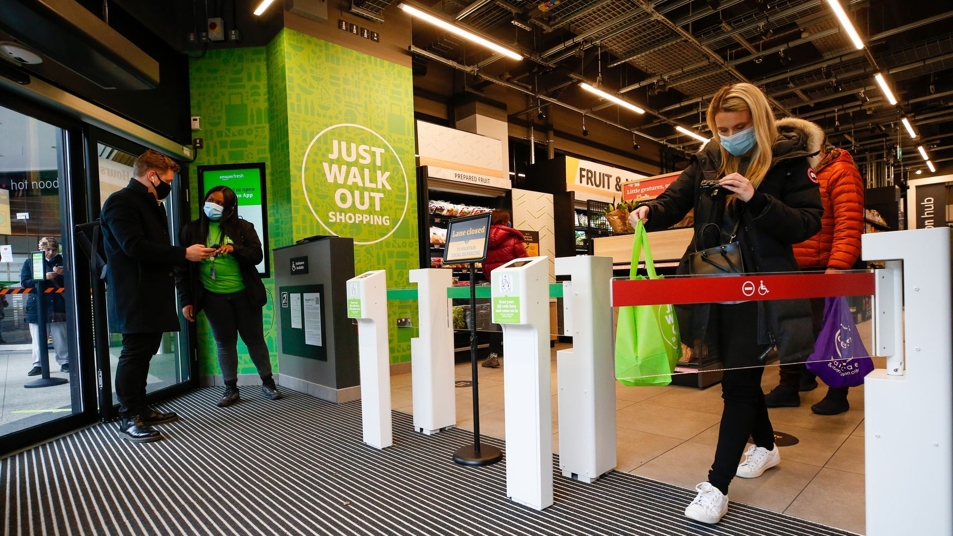 A customer leaves an Amazon Fresh store