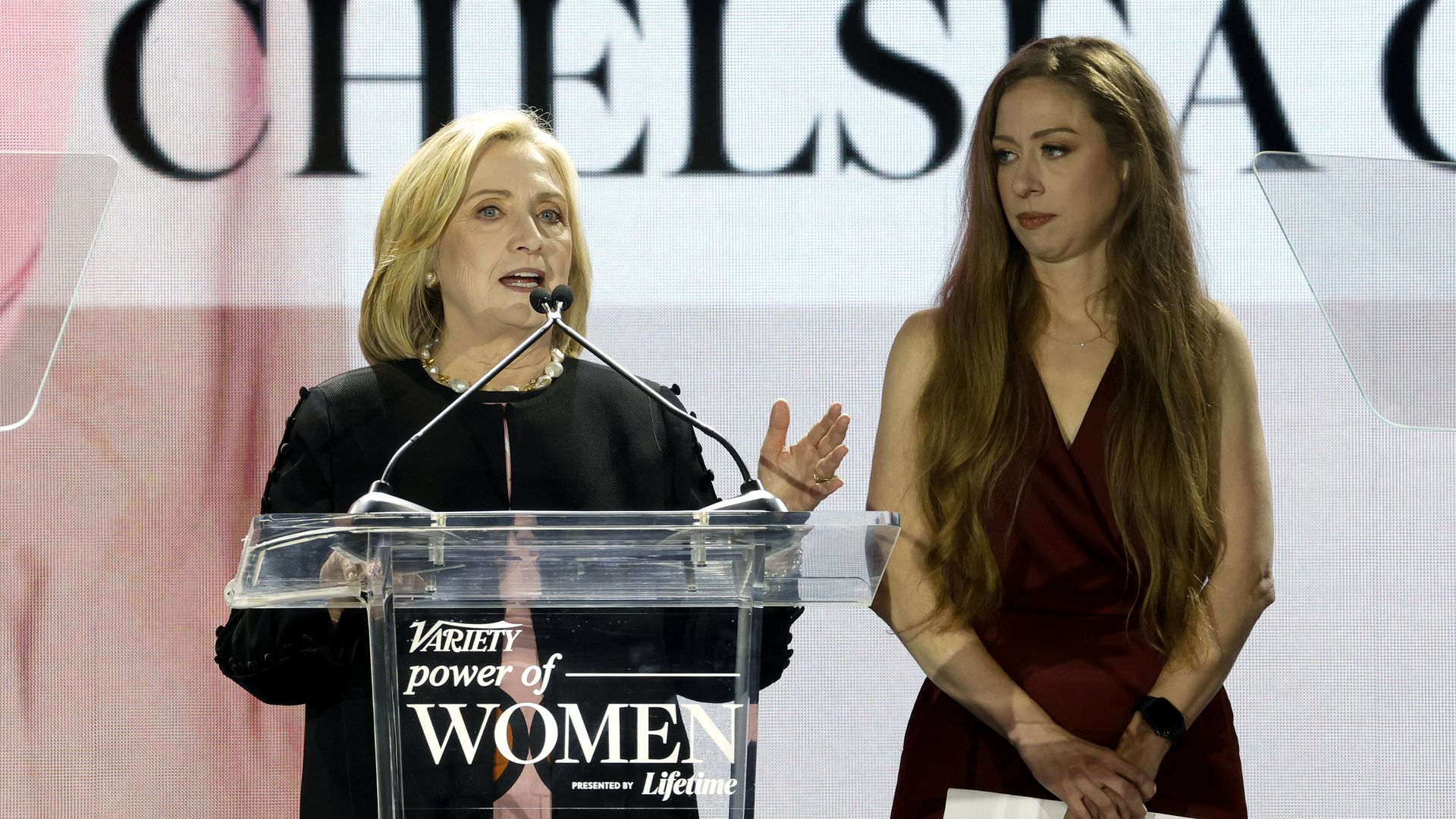 Hillary Clinton and Chelsea Clinton accept an award.