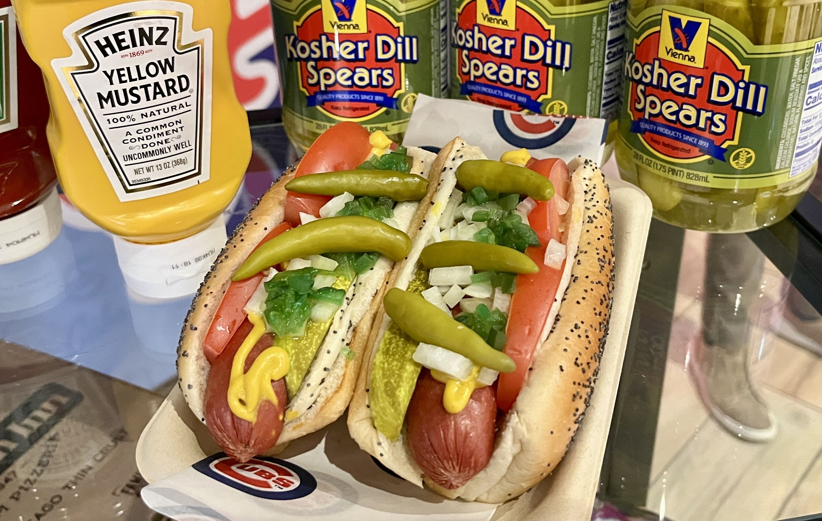 Photo of a hot dog with all the toppings. 