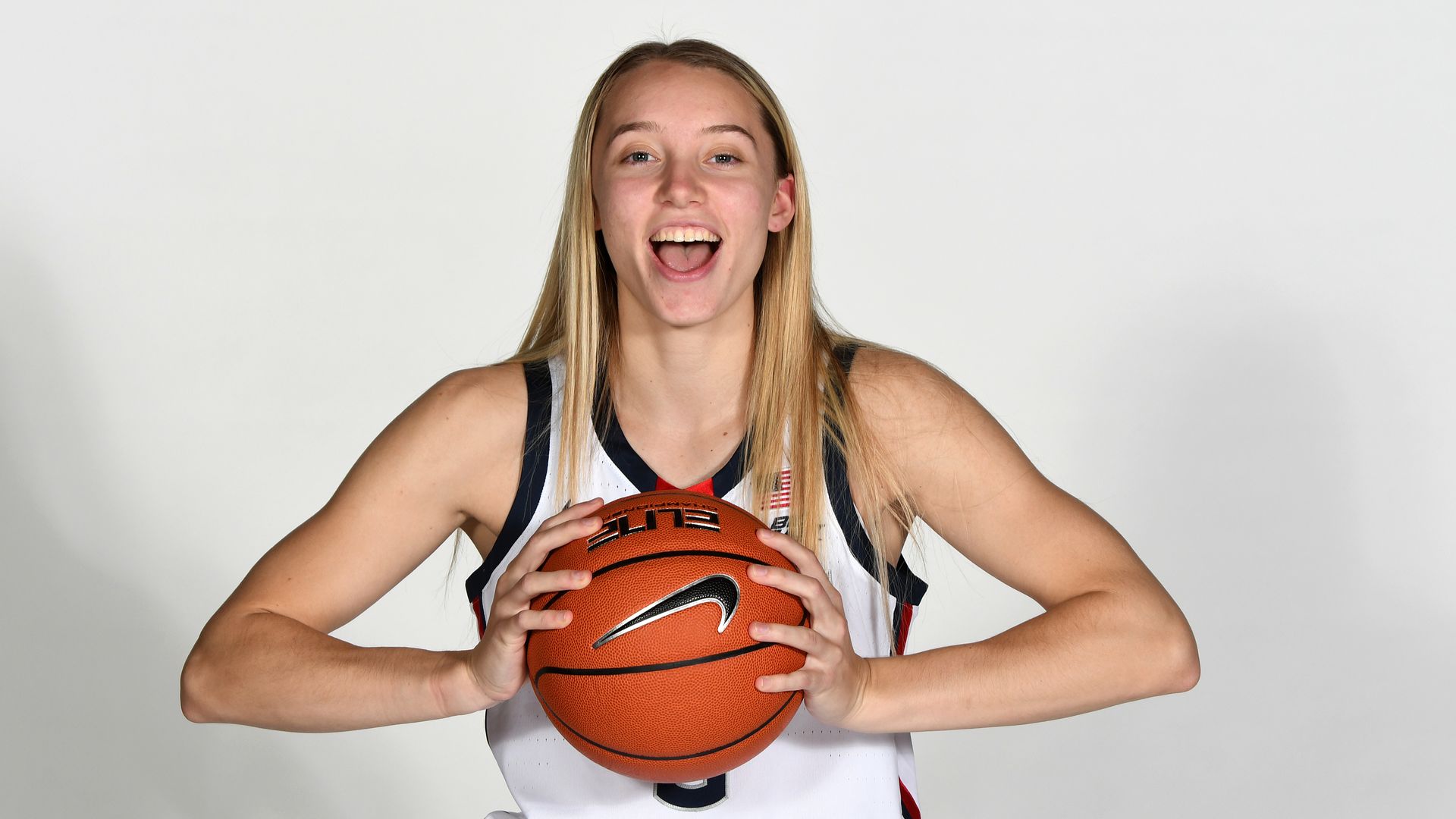 paige bueckers poses with basketball