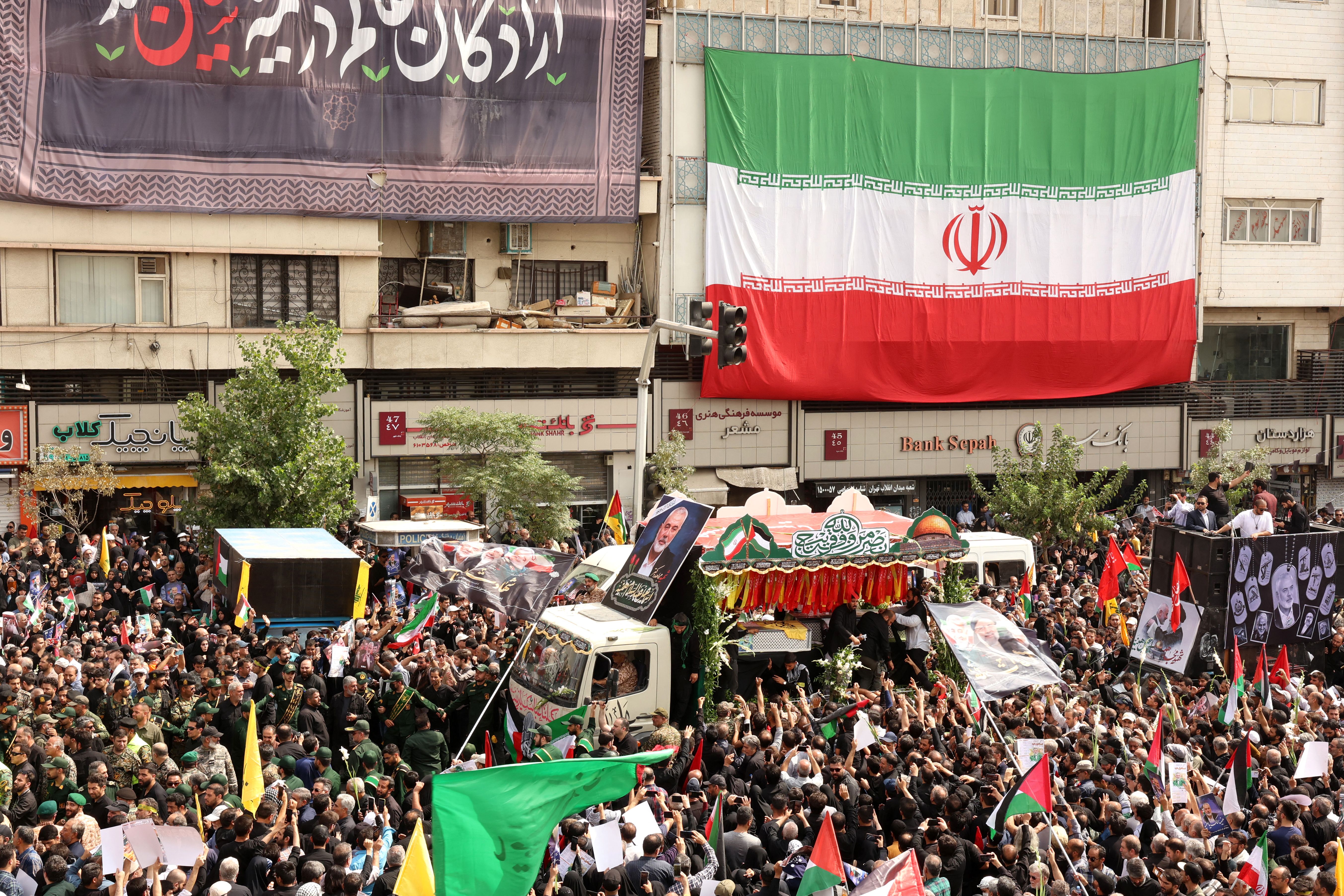 Truck with crowd and big iranian flag