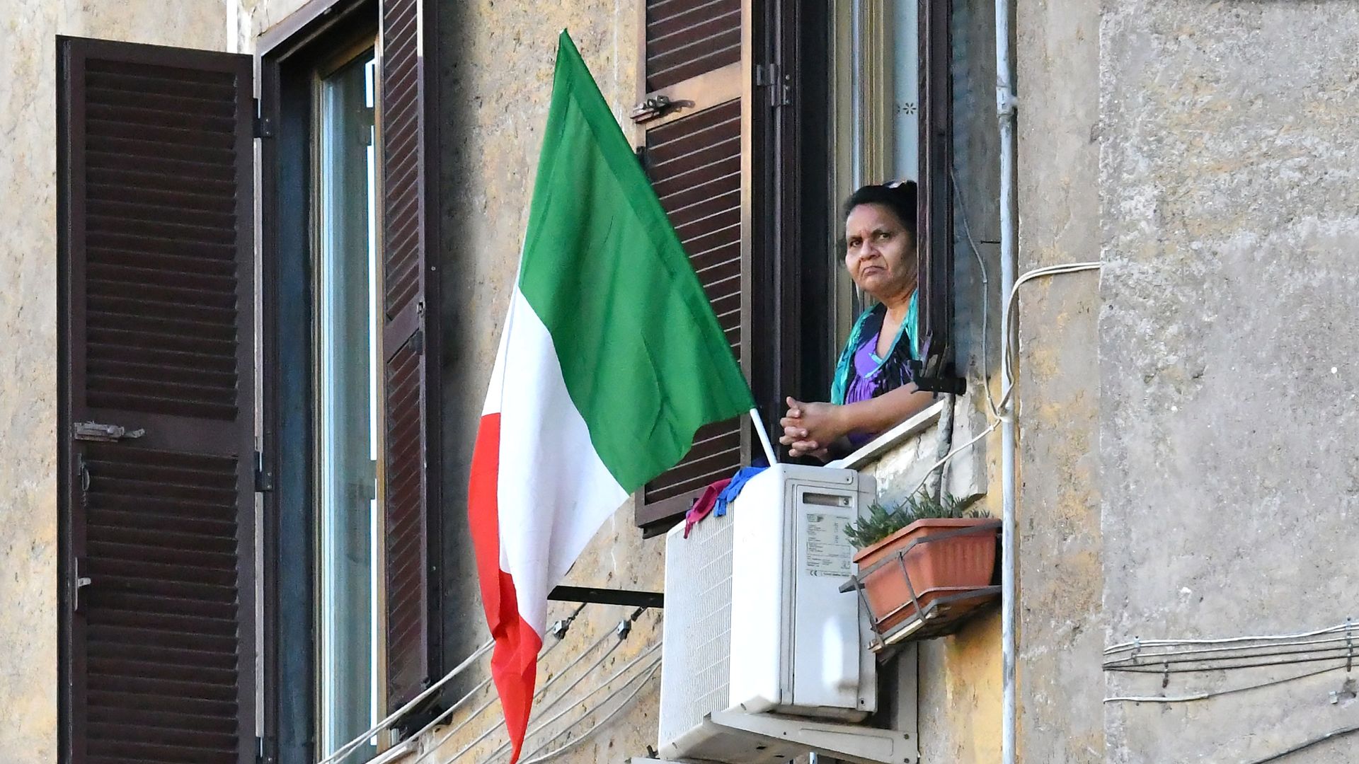 A person looking from their window. 