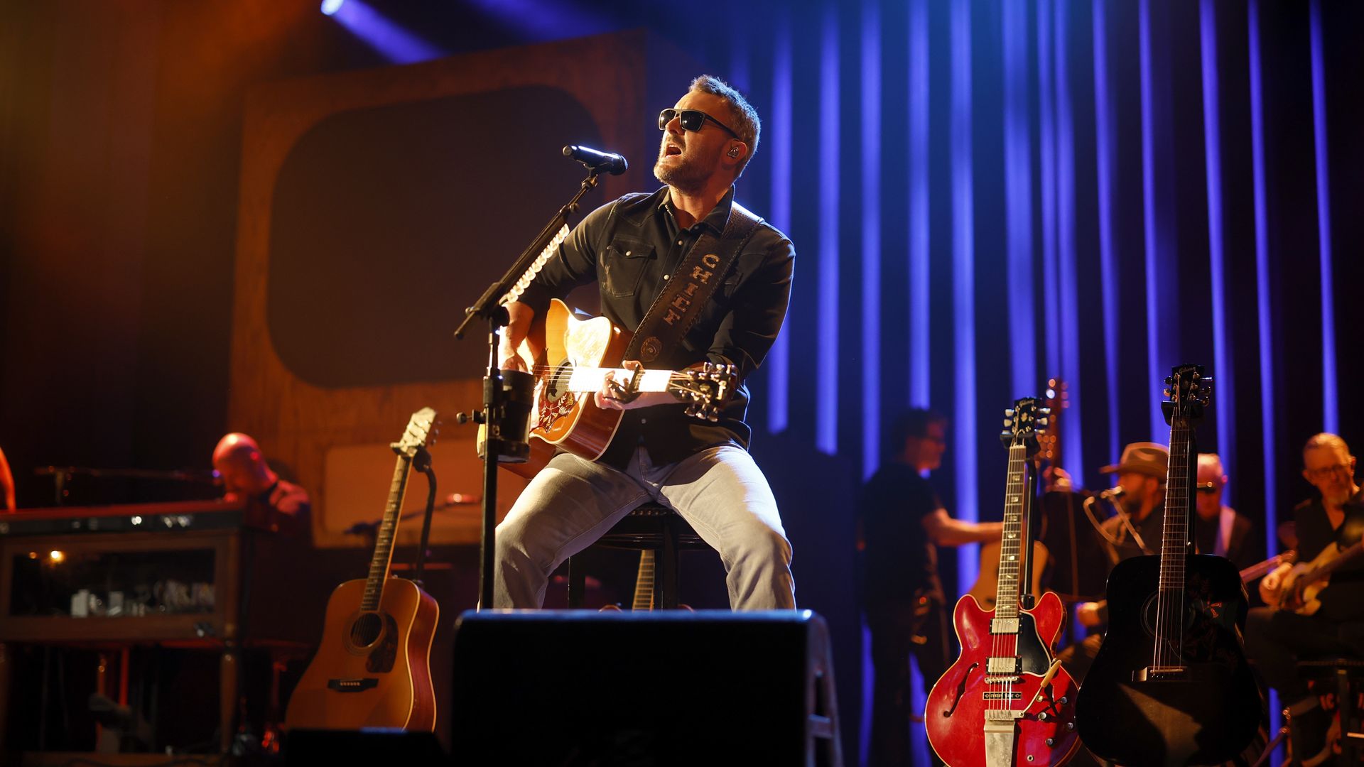 Eric Church plays a guitar. 