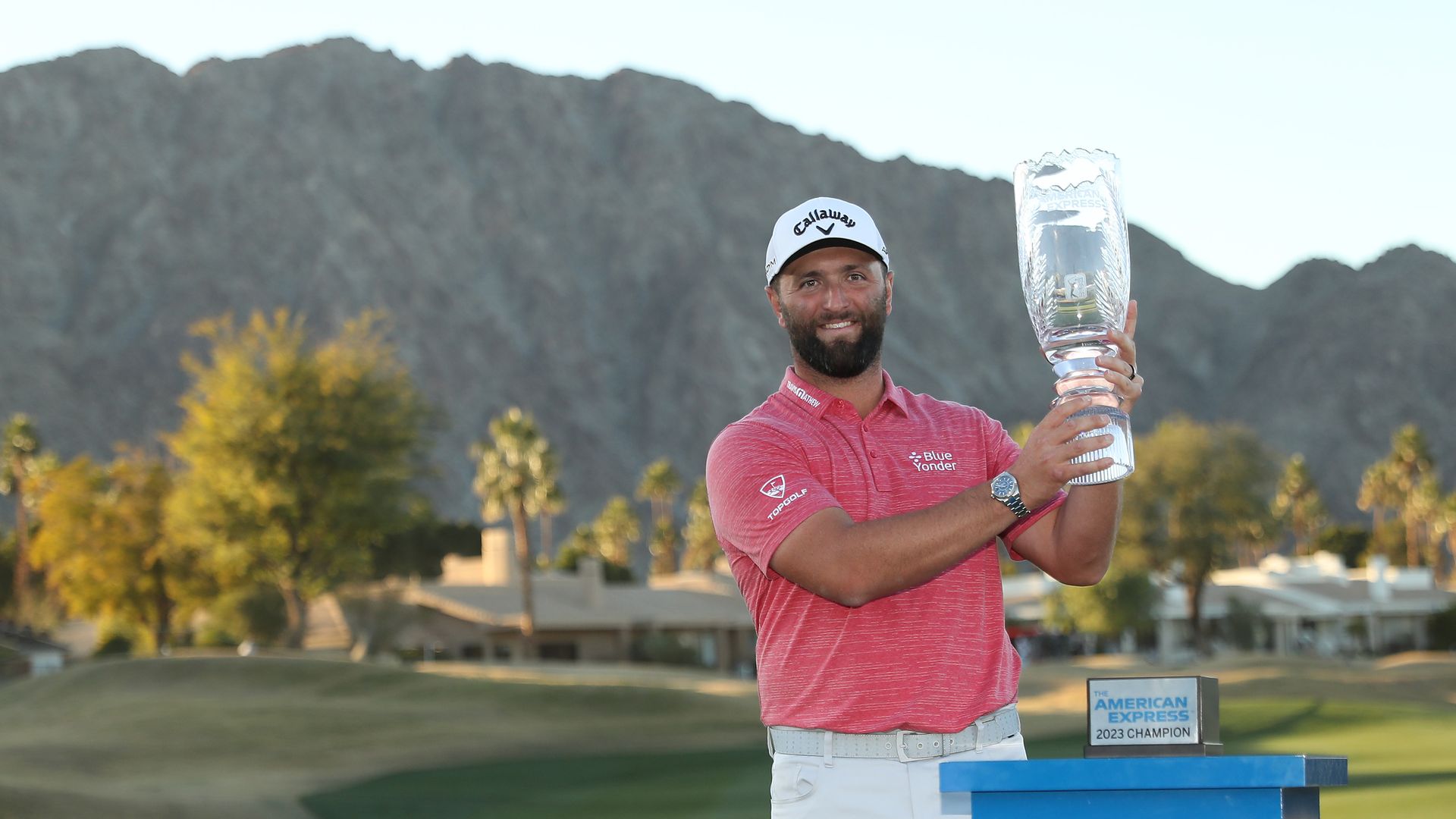 jon rahm holds his trophy