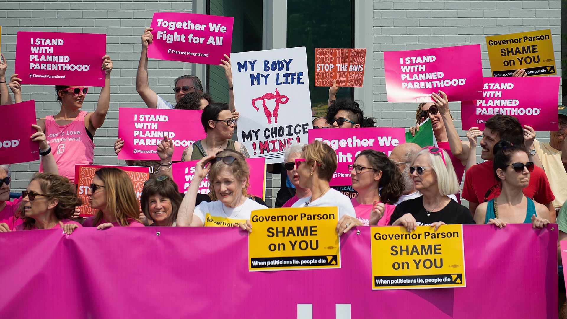 In this image, a line of mostly women protestors hold pro-abortion signs.