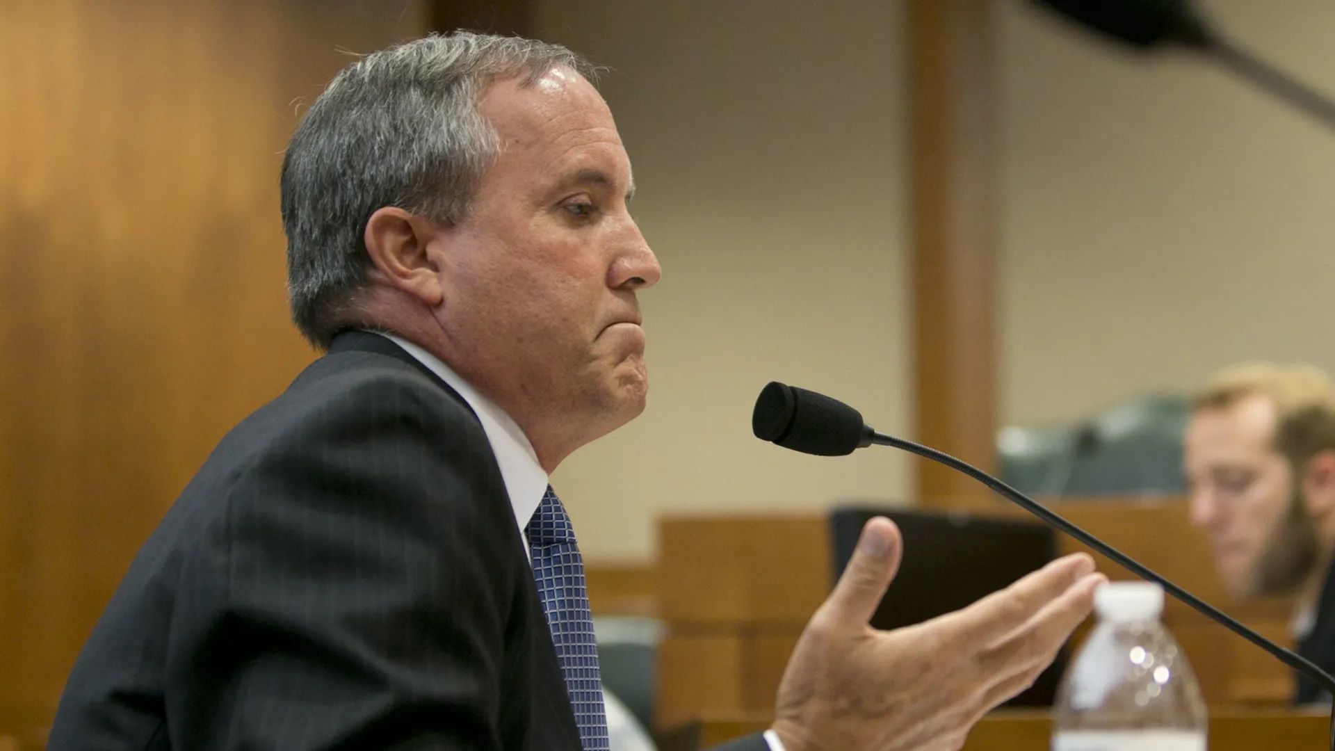 Texas Attorney General Ken Paxton testifying in front of a mic.