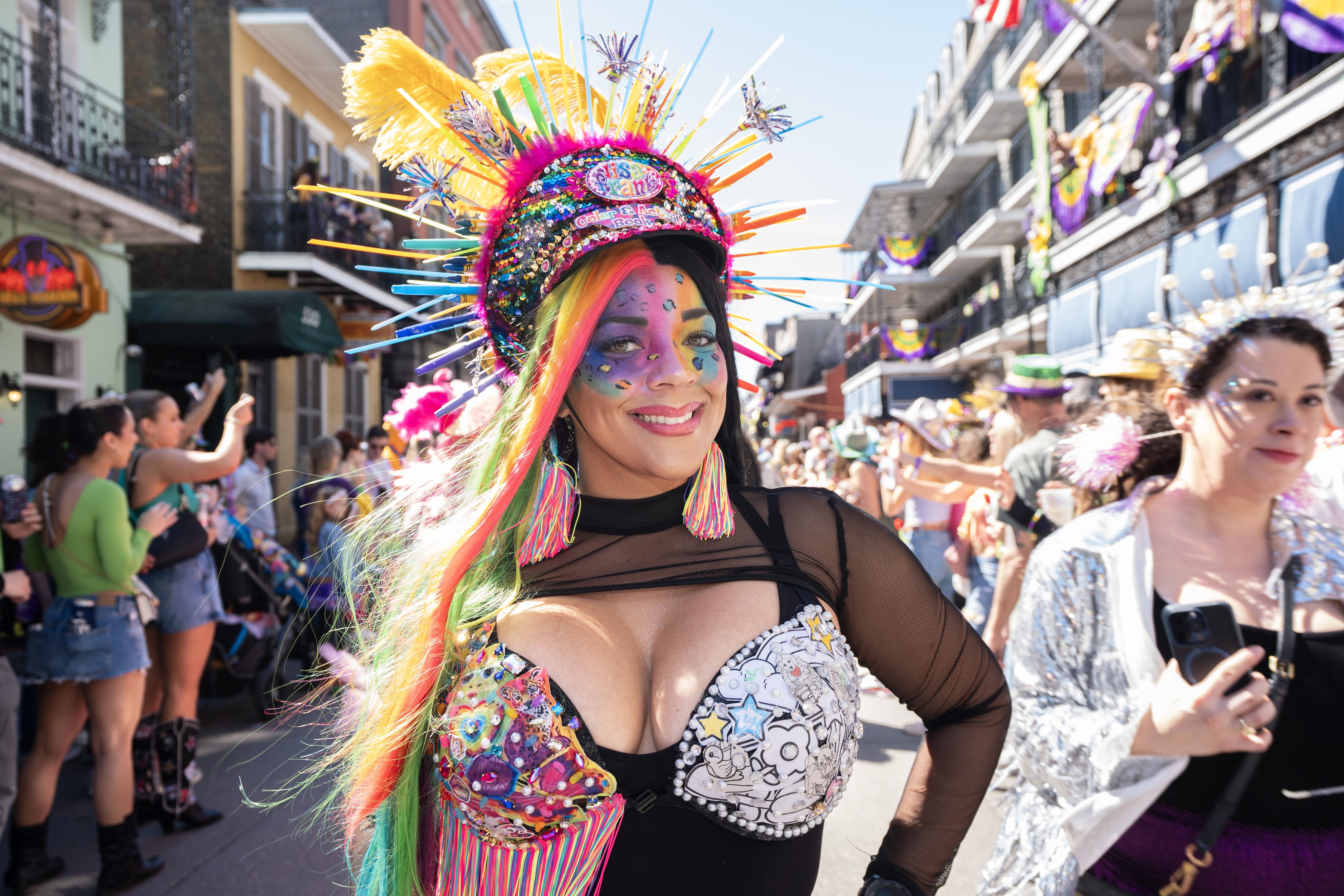 Photo shows a woman in a colorful costume.