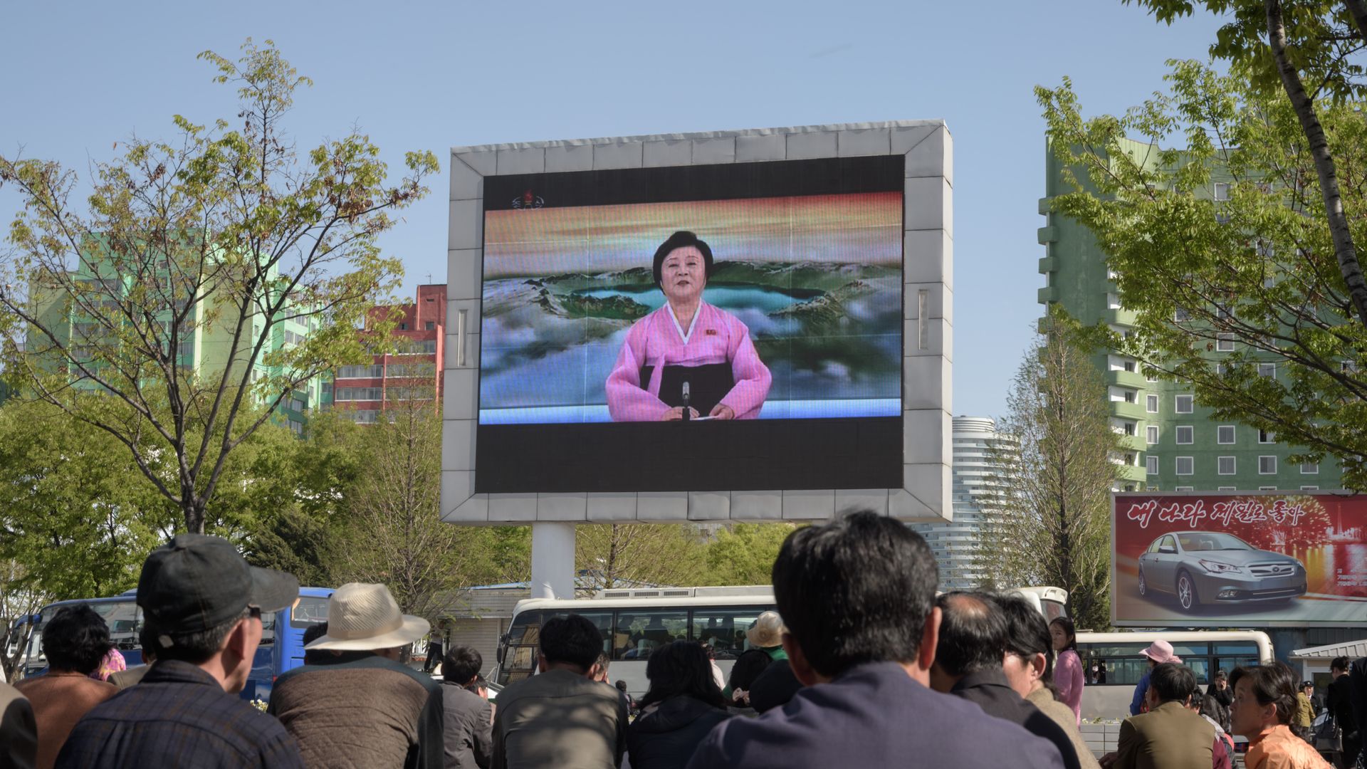 People watch a public television screen showing coverage of the 'Third Plenary Meeting' of the 7th central committee of the ruling Workers' Party, in Pyongyang 