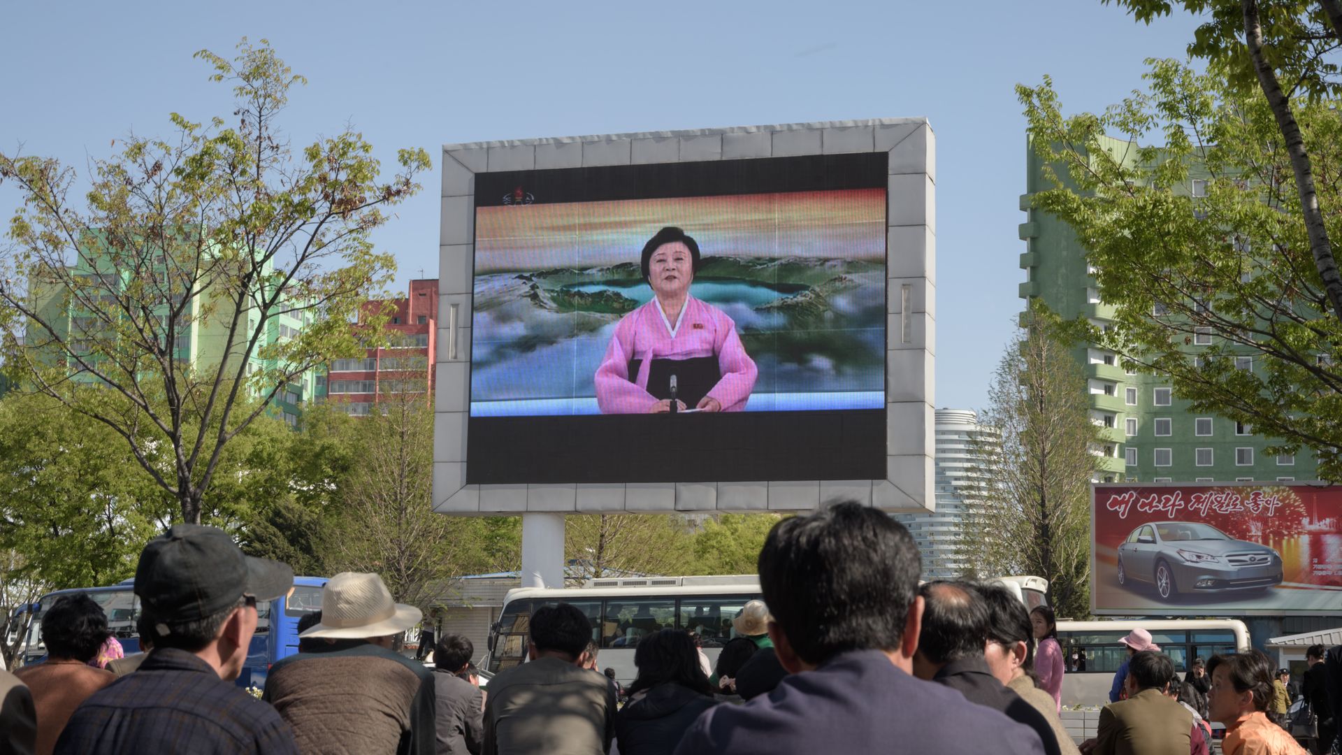 People watch a public television screen showing coverage of the 'Third Plenary Meeting' of the 7th central committee of the ruling Workers' Party, in Pyongyang