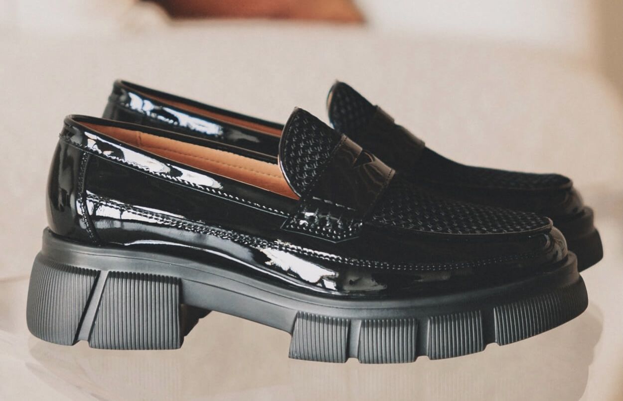 Black patent leather loafers with a chunky sole.