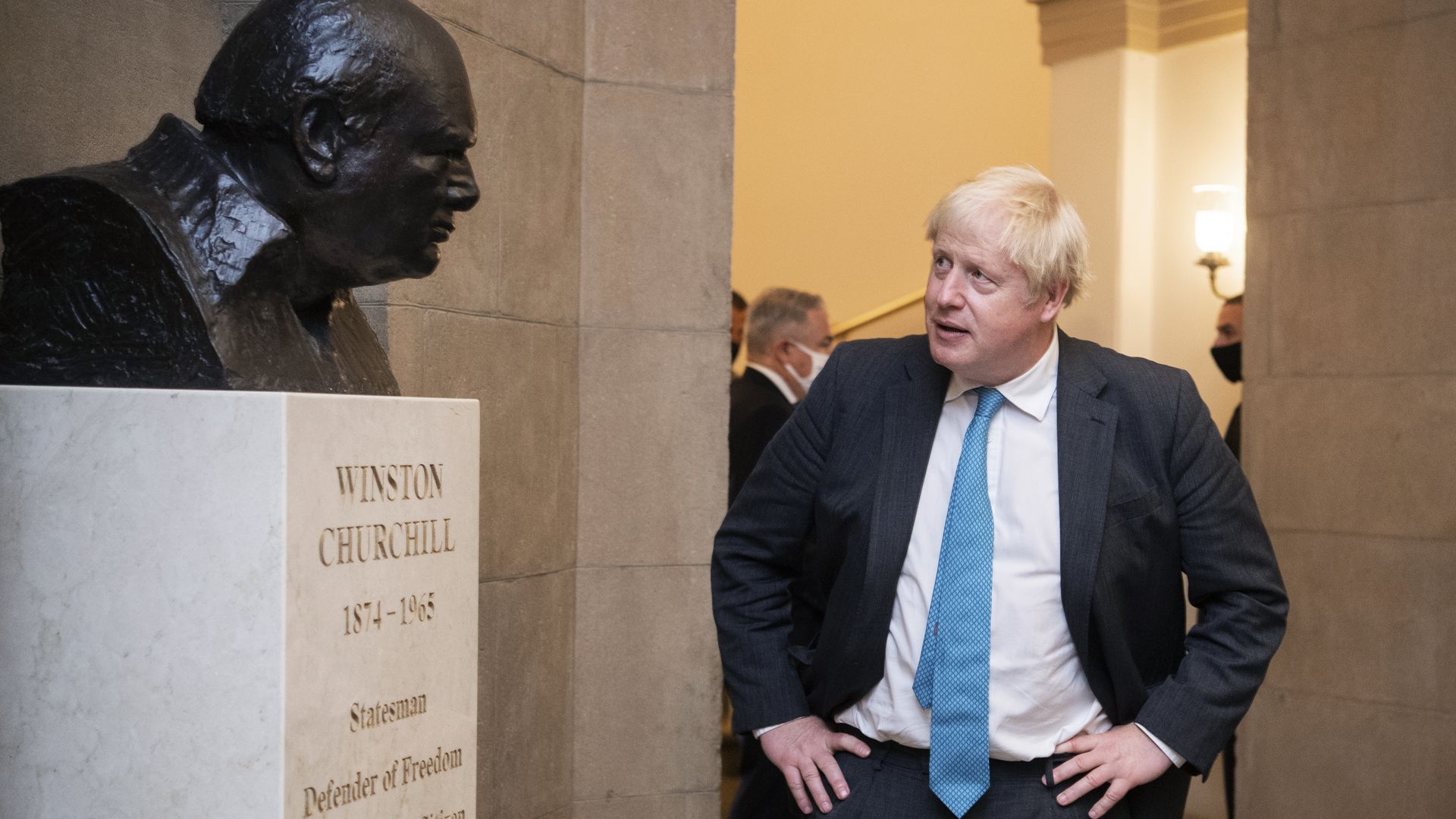 British Prime Minister Boris Johnson is seen looking at a bust of his predecessor Winston Churchill inside the U.S. Capitol.