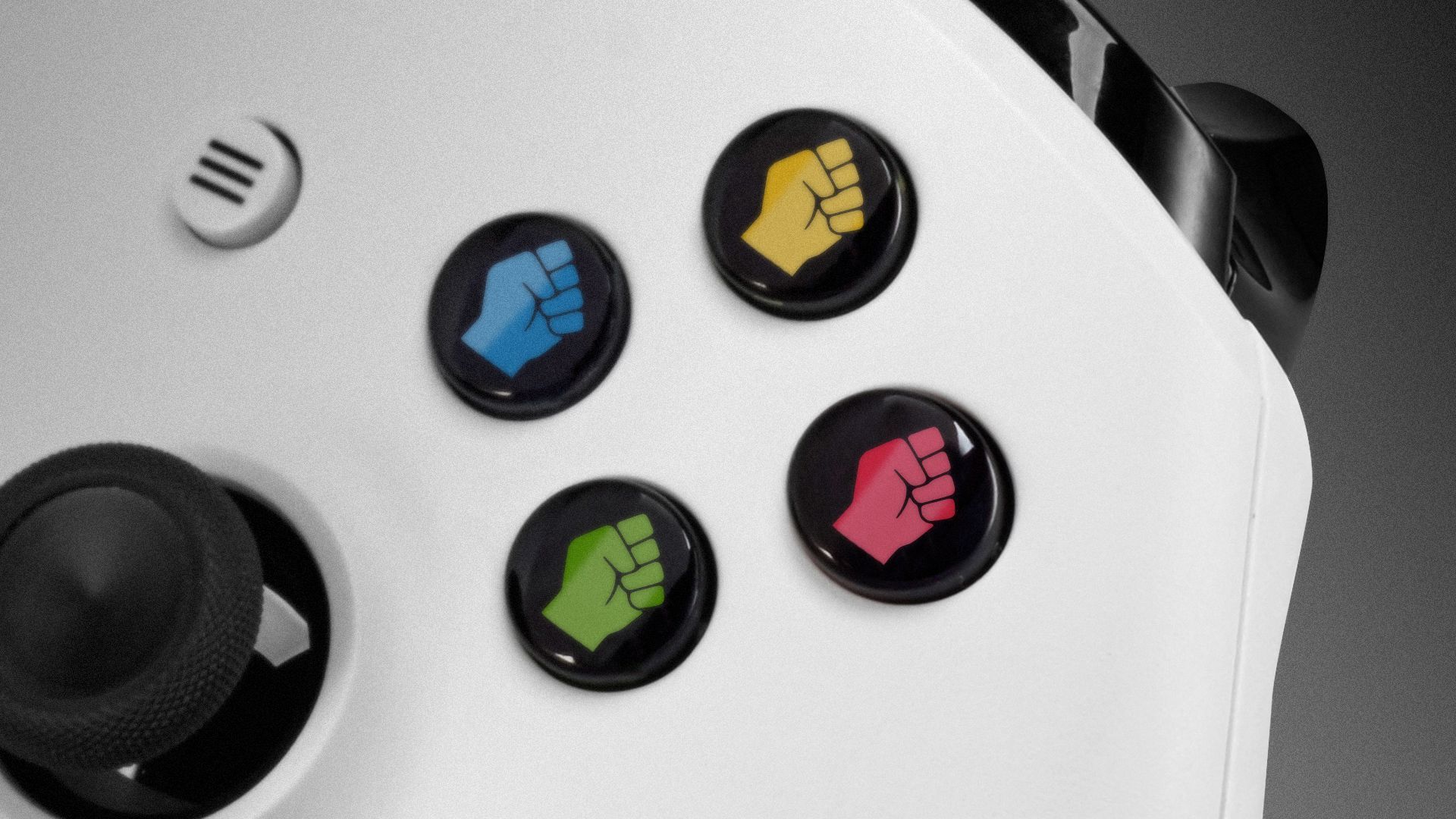 Illustration of a gaming controller with different fist icons on the buttons. 