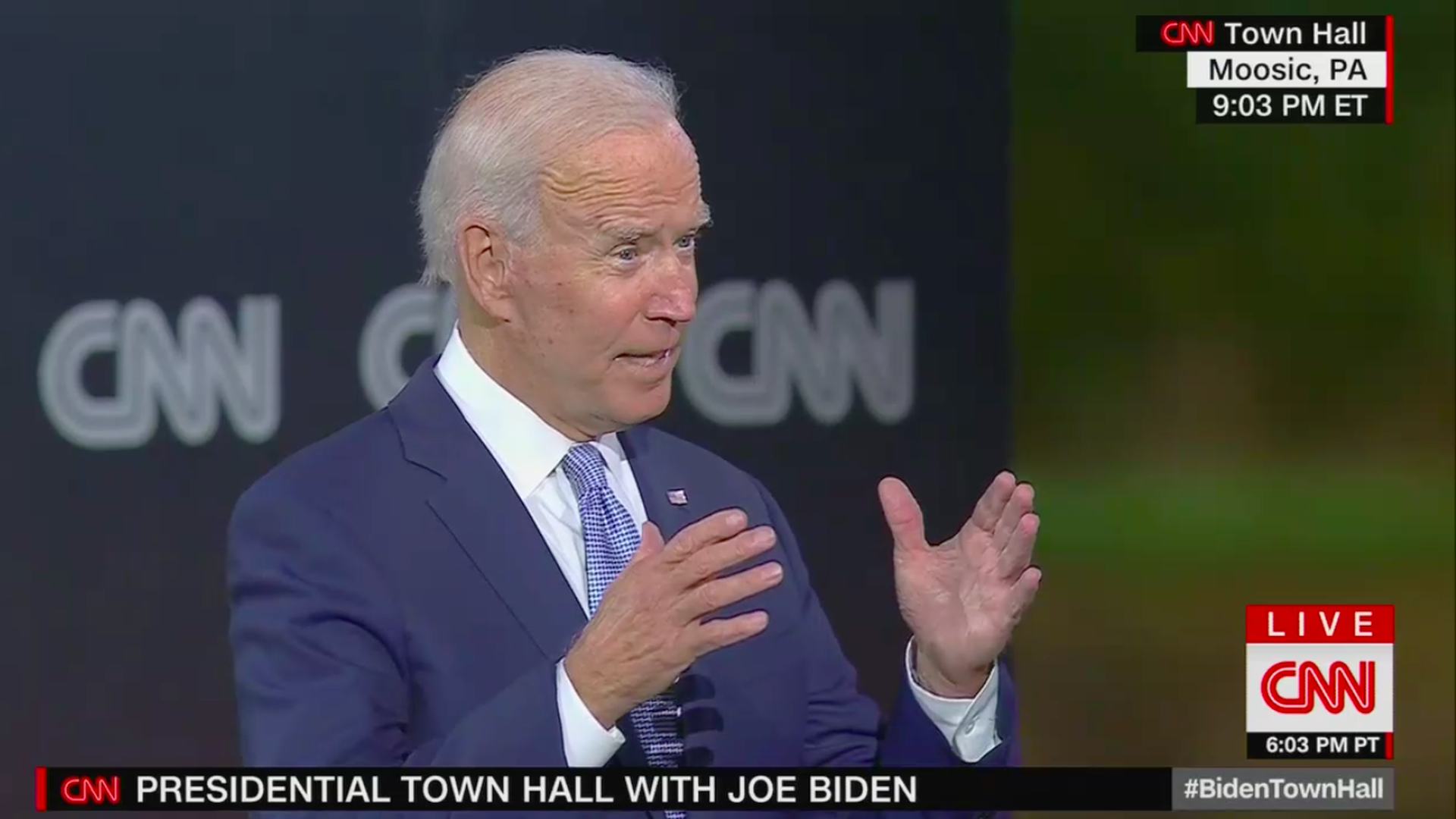 Biden speaks while gesturing with his hands 