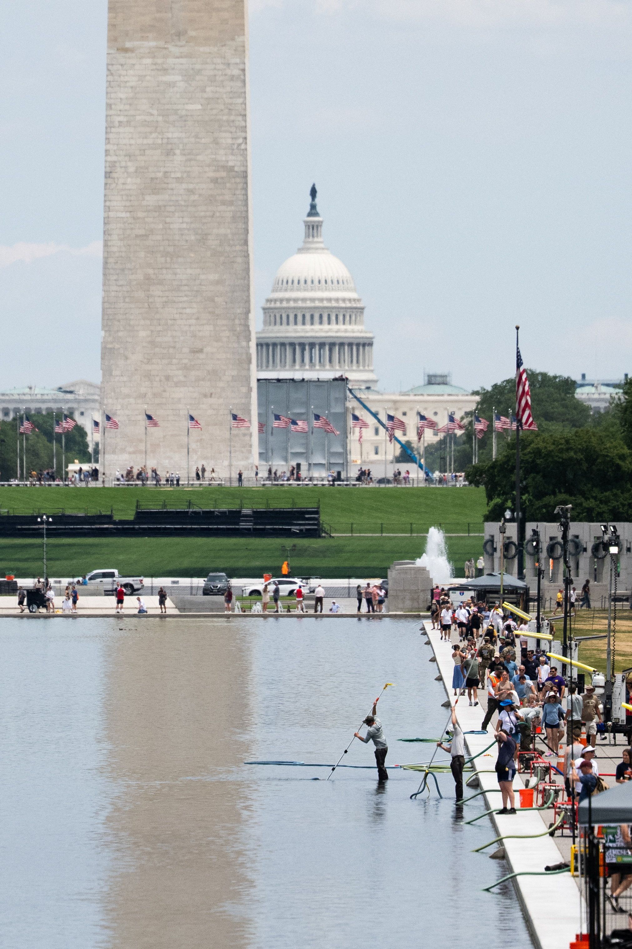 Workers vacuum algae from the Lincoln Memorial Reflecting Pool, after recent renovations following a directive from U.S. President Donald Trump to paint it blue ahead of the 250th anniversary of U.S. Independence, in Washington, D.C., U.S., June 21, 2026.