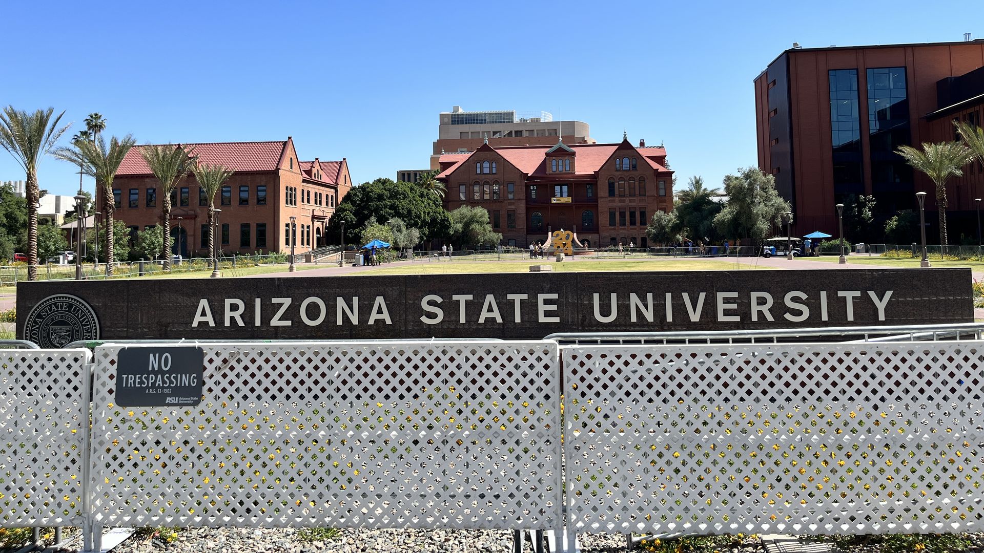 A fence around a sign that says "Arizona State University.