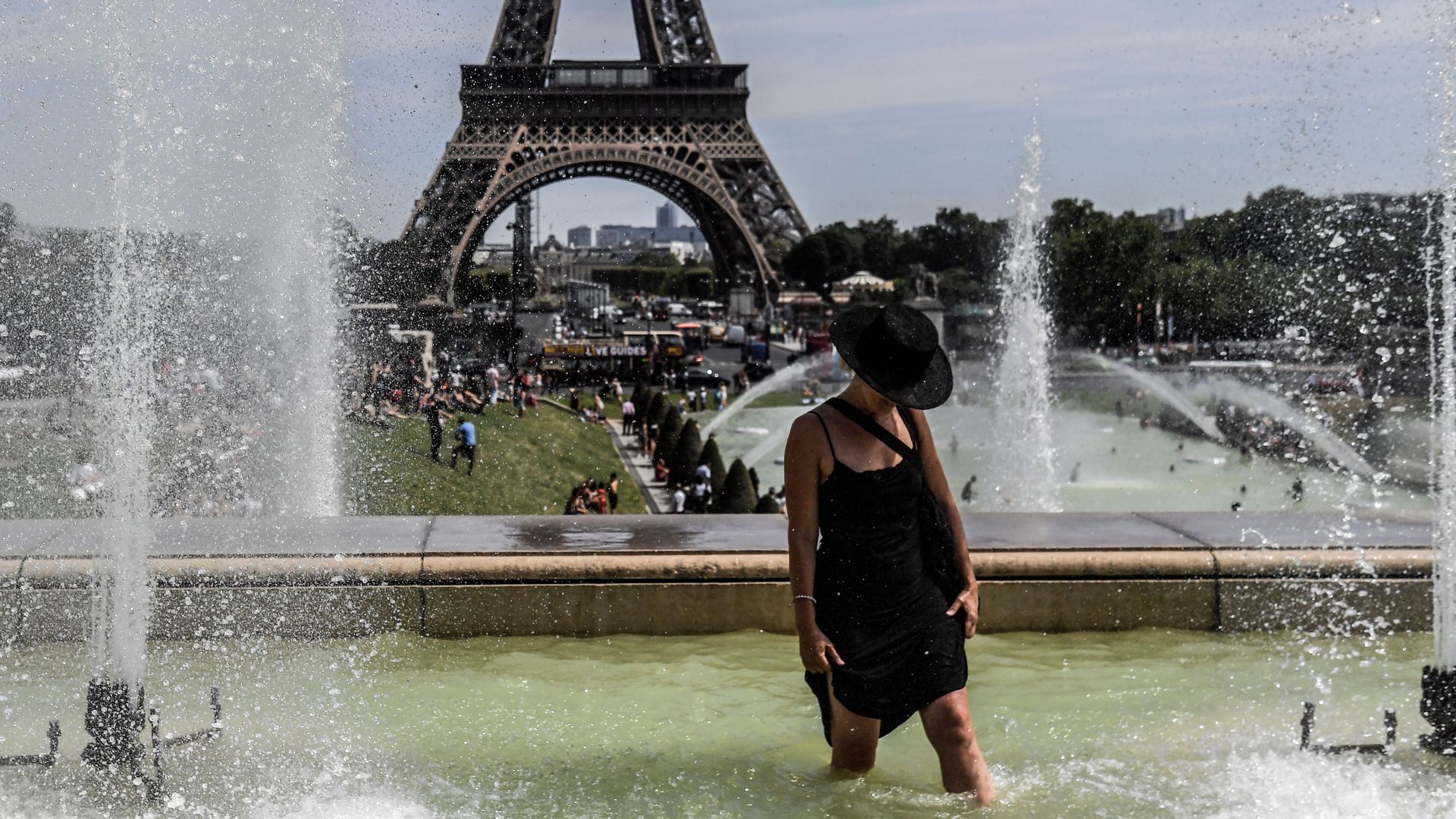 A woman cools off at the Trocadero Fountains near the Eiffel Tower in Paris, on July 22.