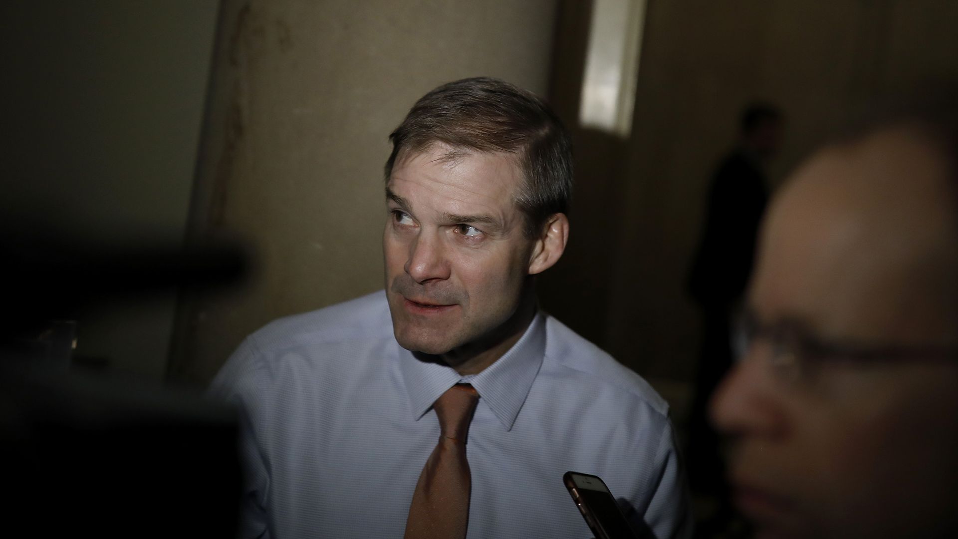 Jim Jordan highlighted in the center of a dark shadow