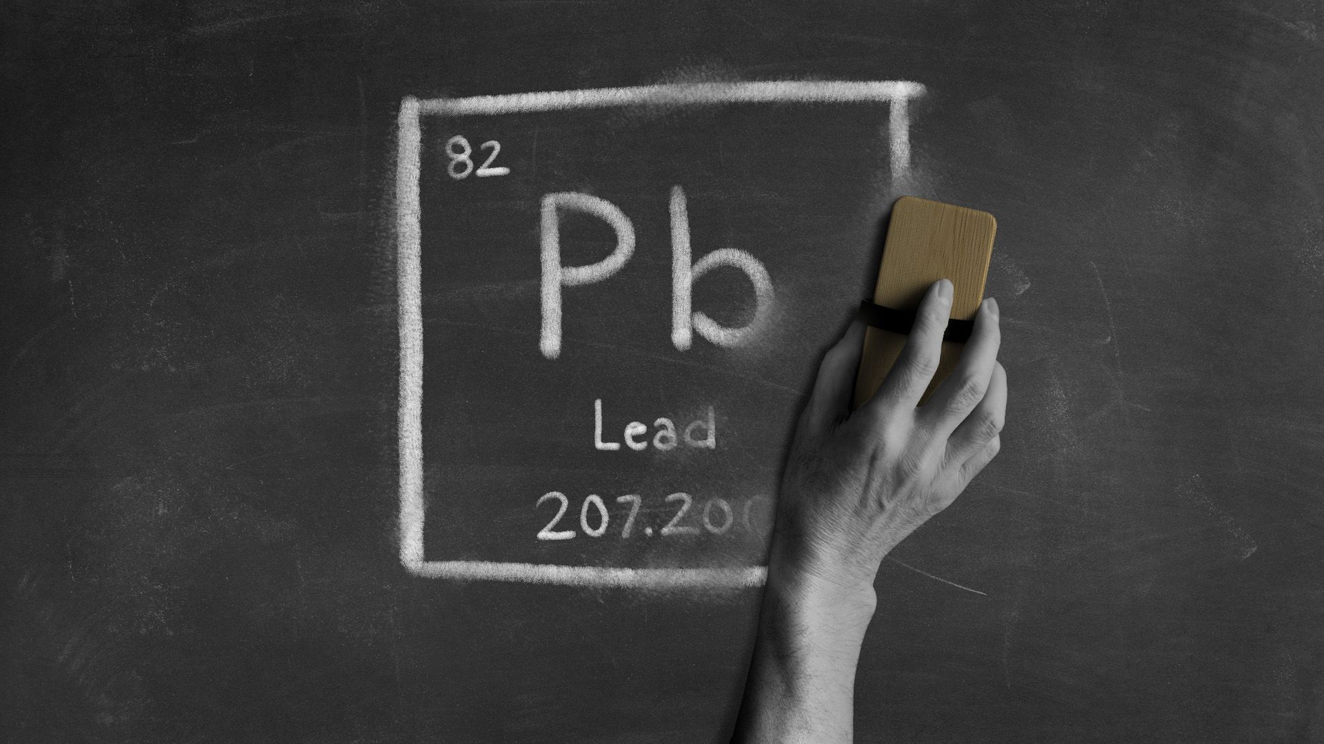 Illustration of the chemical symbol for lead written on a chalkboard, being erased. 