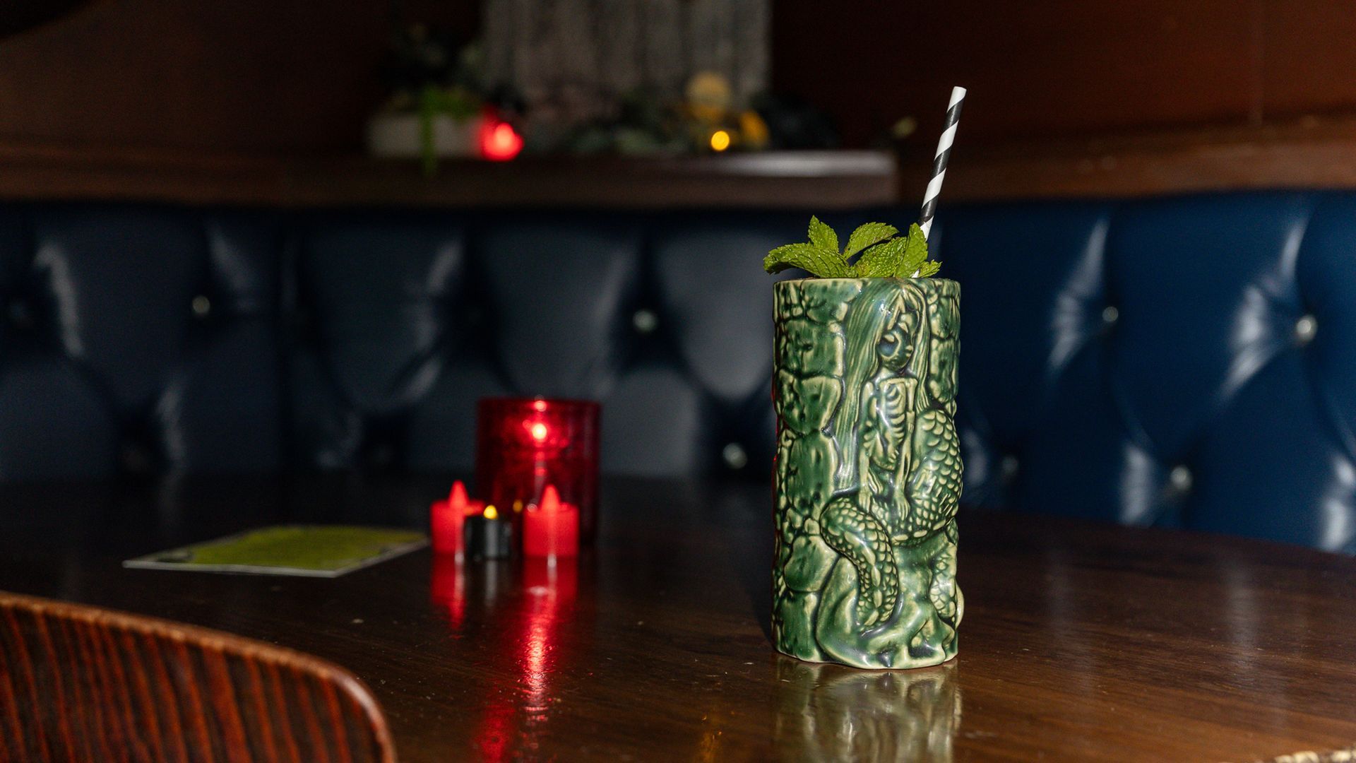 Photo of an intricately carved green glass sitting on a table