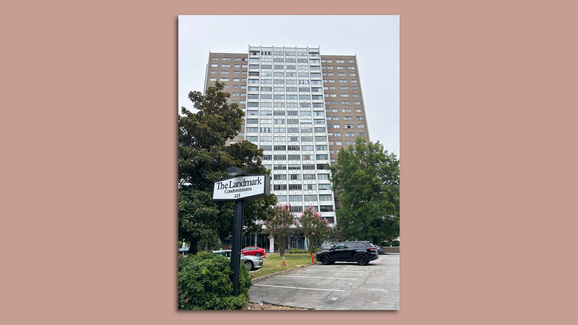 A photo of a 20-story condominium tower with a sign that says "The Landmark"