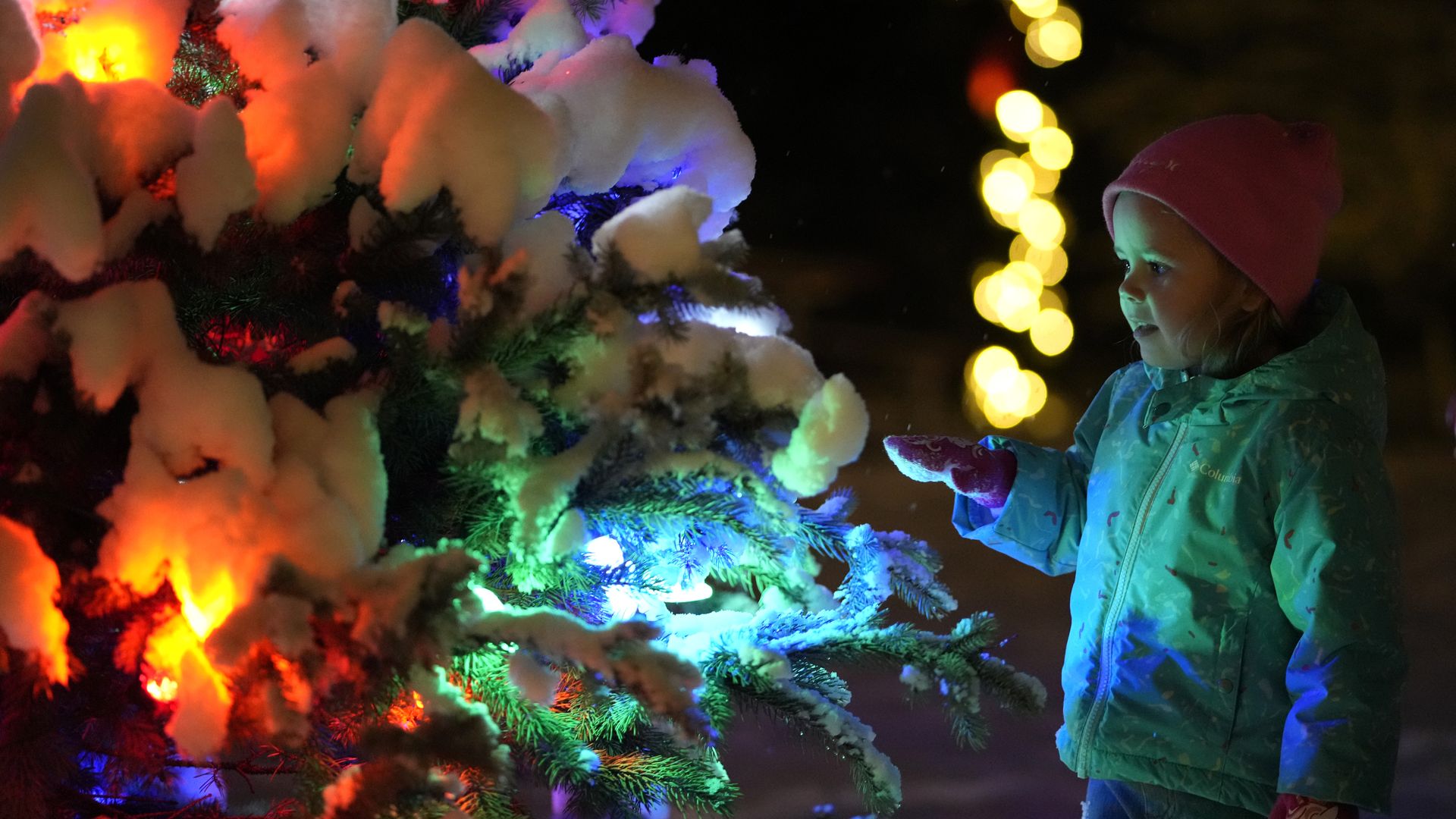 A photo of a child with holiday lights.