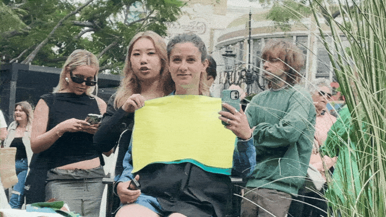 GIF with color analyst lifting yellow fabric to reveal turquoise fabric