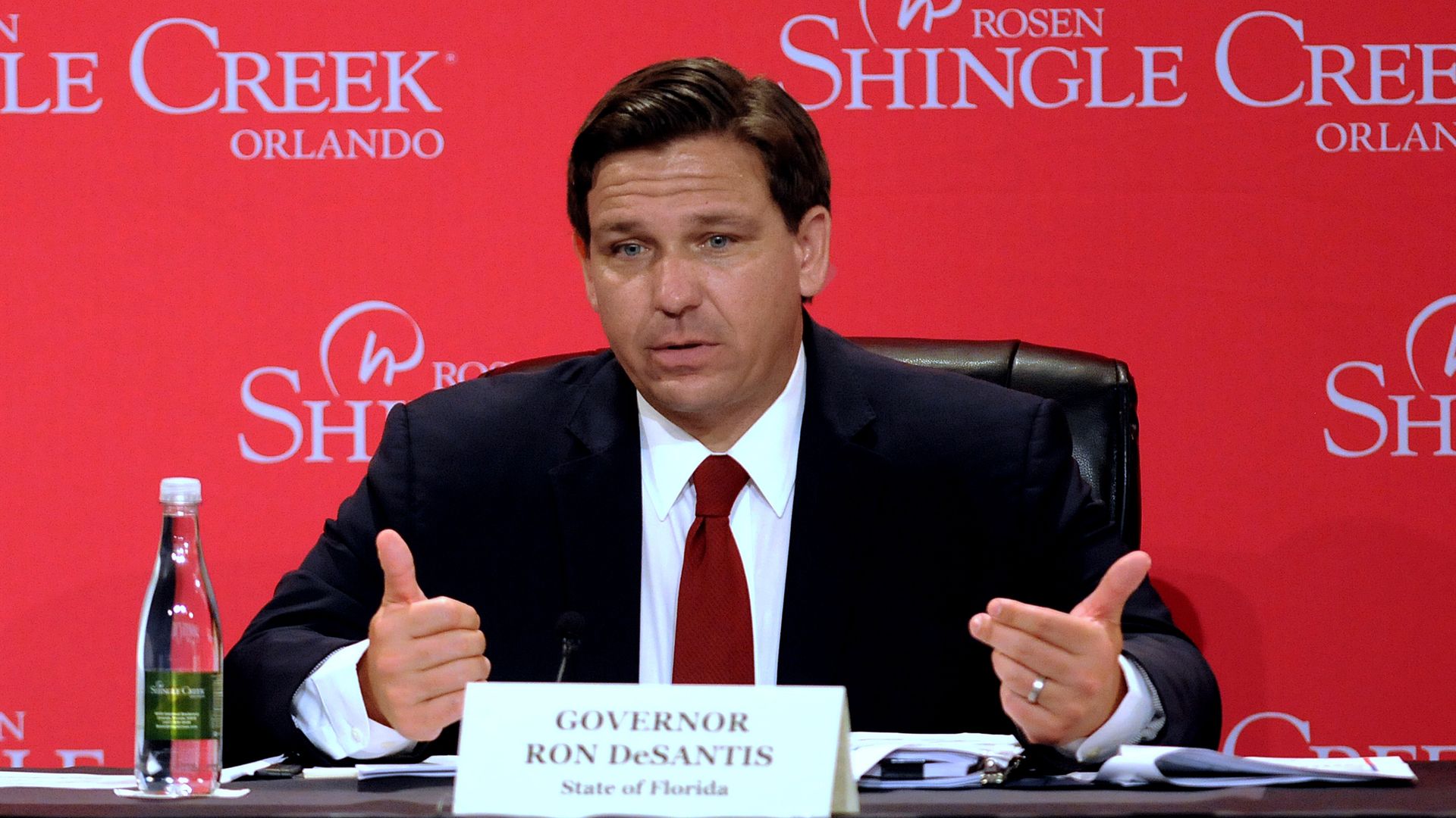 In this image, Ron DeSantis speaks while wearing a suit