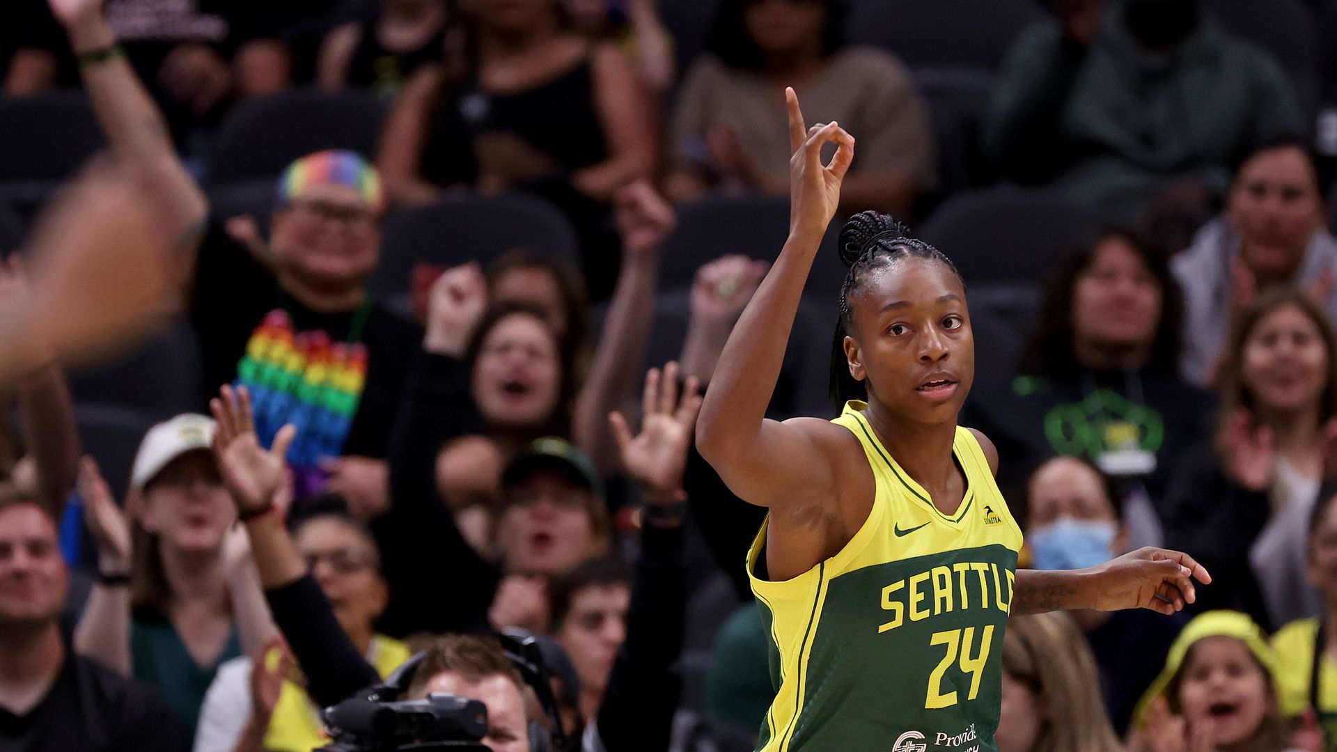 NBA player Jewell Loyd holds up a hand during a Seattle Storm game. 