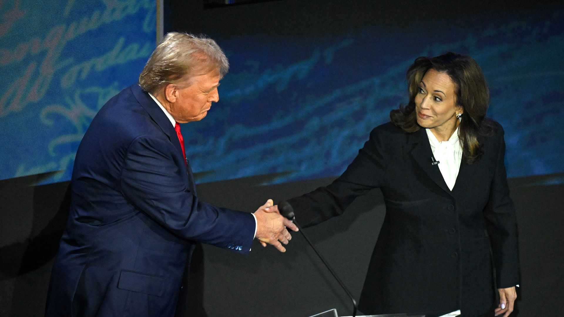 US Vice President and Democratic presidential candidate Kamala Harris (R) shakes hands with former US President and Republican presidential candidate Donald Trump during a presidential debate at the National Constitution Center in Philadelphia, Pennsylvania, on September 10, 2024.