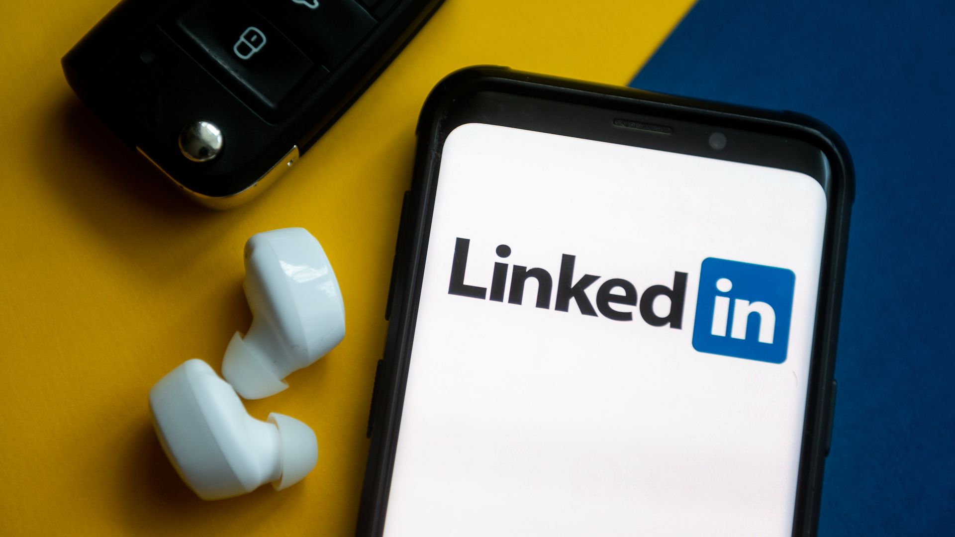 An illustration with the LinkedIn logo displayed on a smartphone.