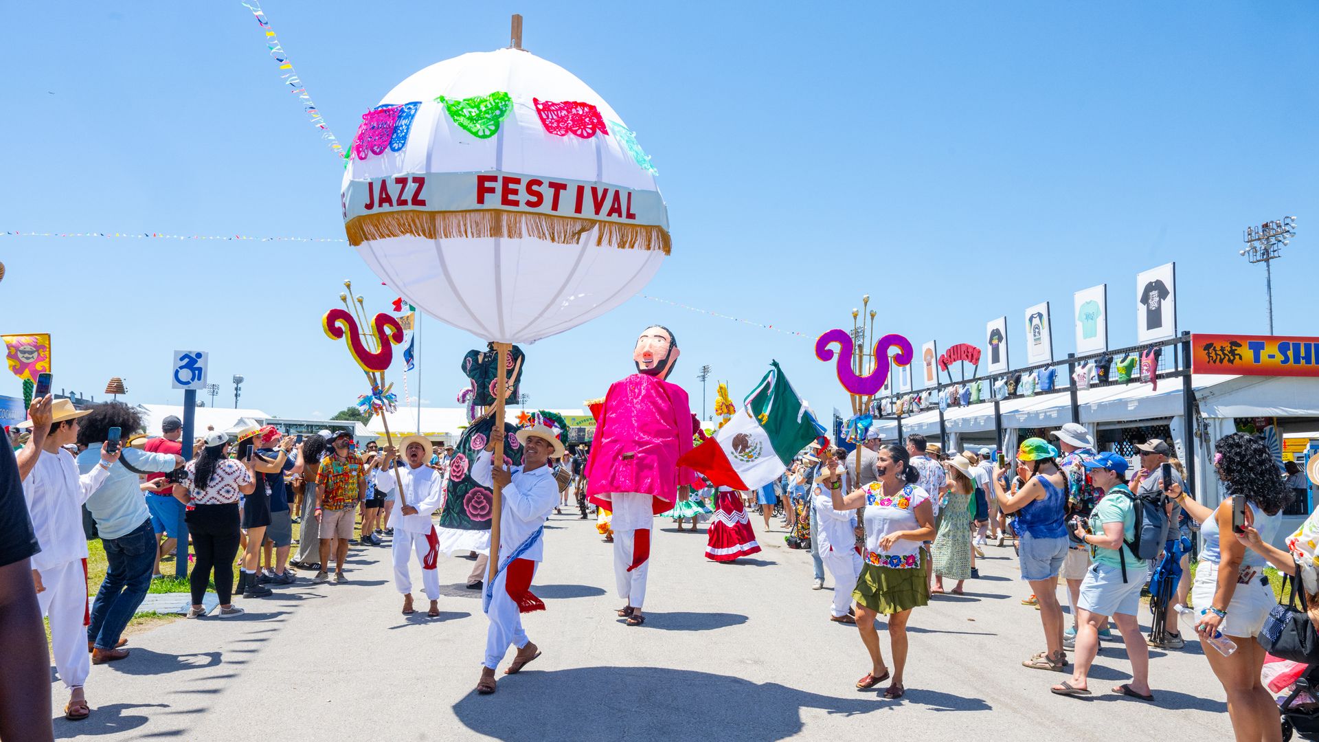 A parade traverses the race track during the New Orleans Jazz & Heritage Festival at Fair Grounds Race Course.