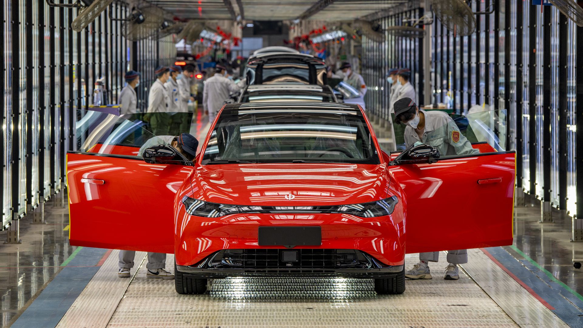 Employees work on the assembly line of C01 electric sedan at a factory of Chinese EV startup Leapmotor on October 29, 2022 in Jinhua, Zhejiang Province of China.