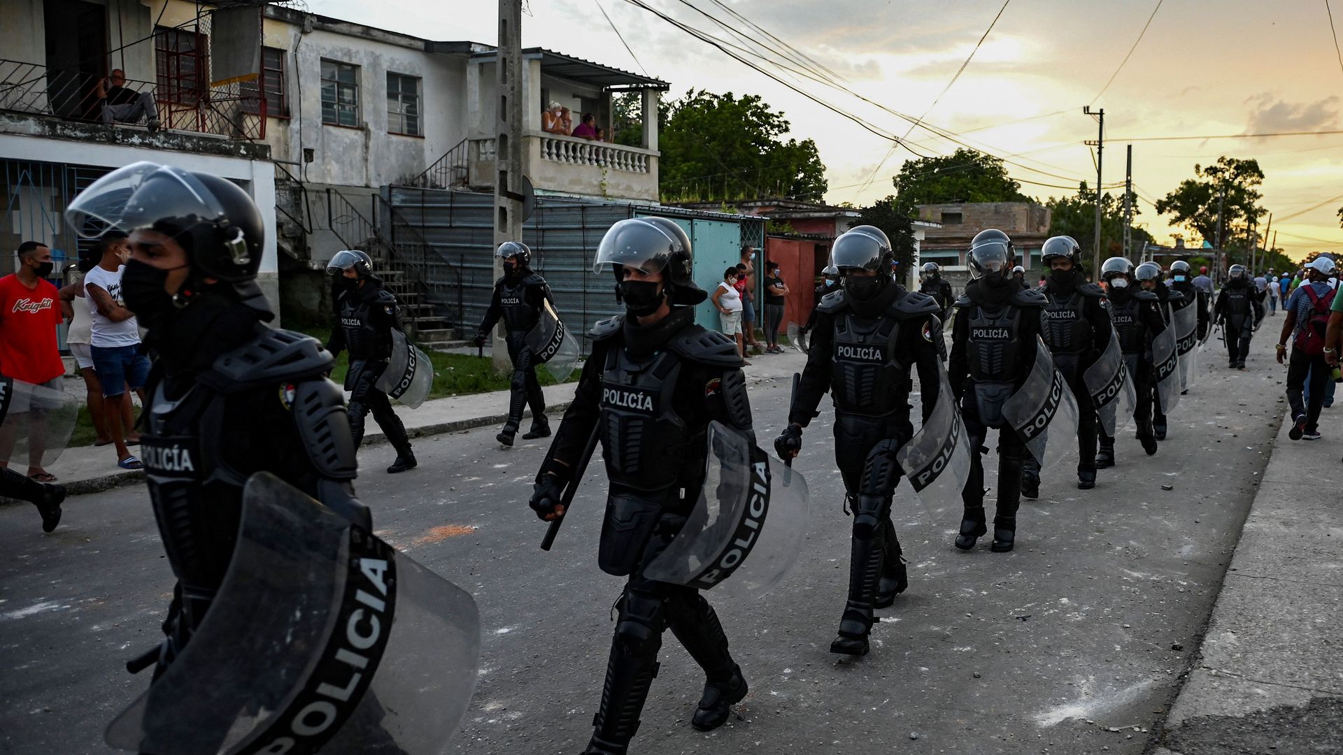 -Riot police walk the streets after a demonstration against the government of President Miguel Diaz-Canel in Arroyo Naranjo Municipality, Havana on July 12
