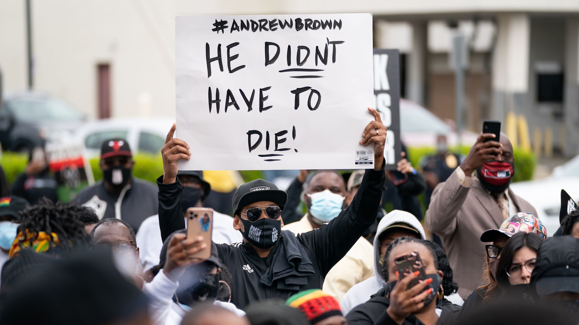 Demonstrators gather outside a government building during an emergency city council meeting