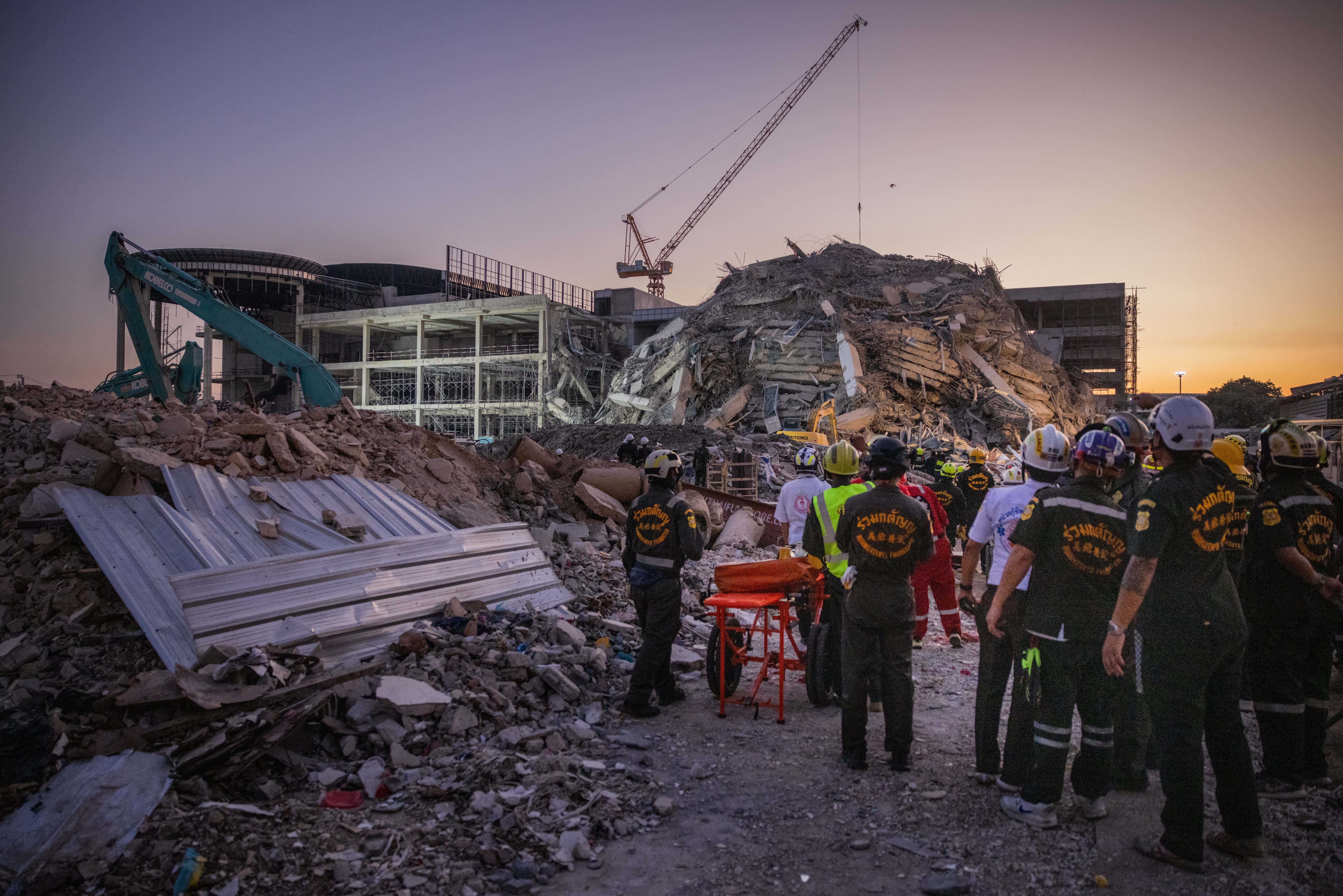 Thai rescue teams provide aid at a construction building collapse in Bangkok's Chatuchak area on March 28