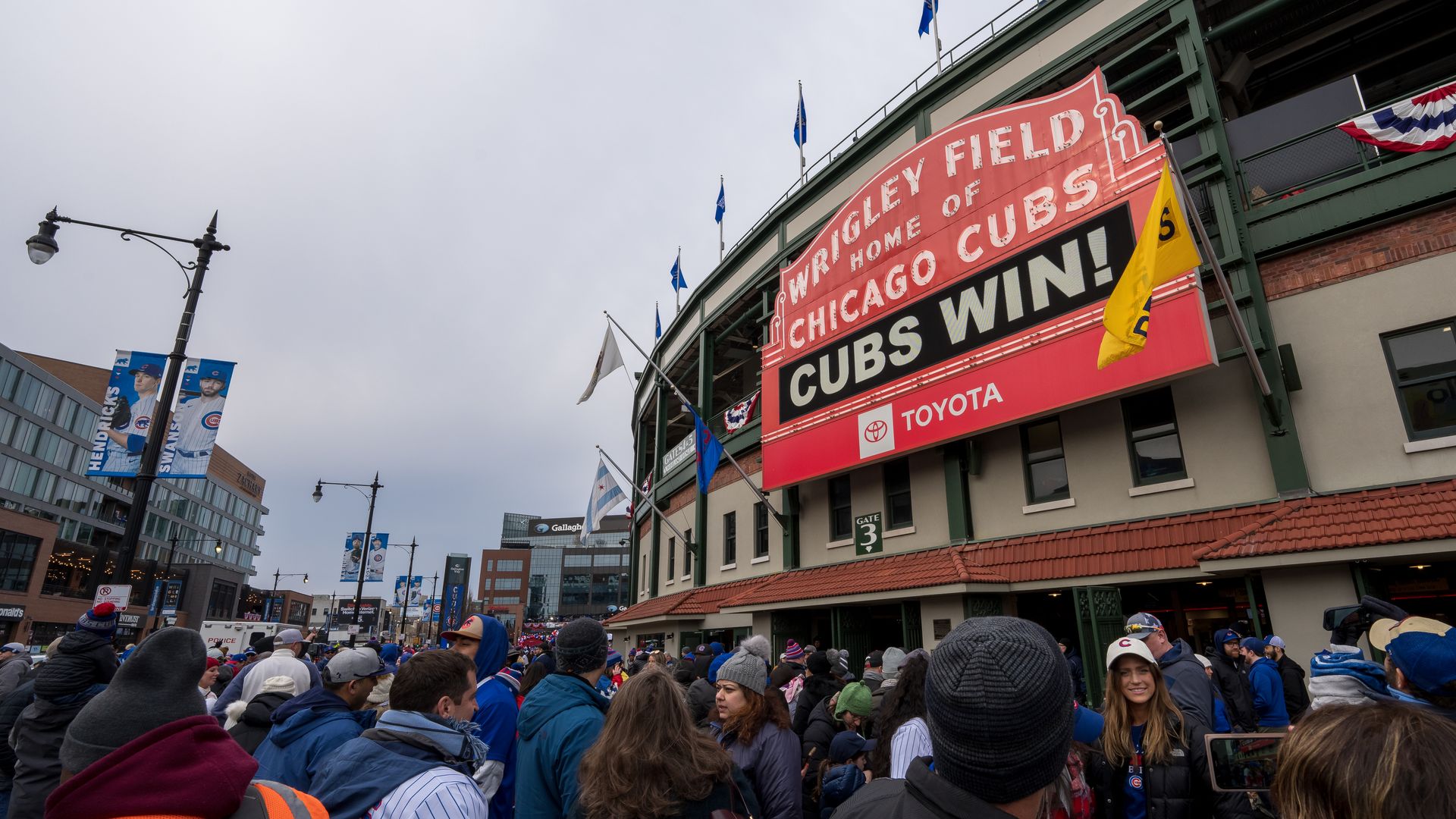 The sign in front of Wrigley Field that says "Cubs Win" 