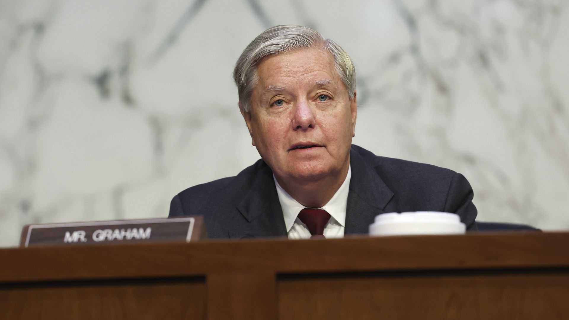 Photo of Lindsey Graham sitting behind a table
