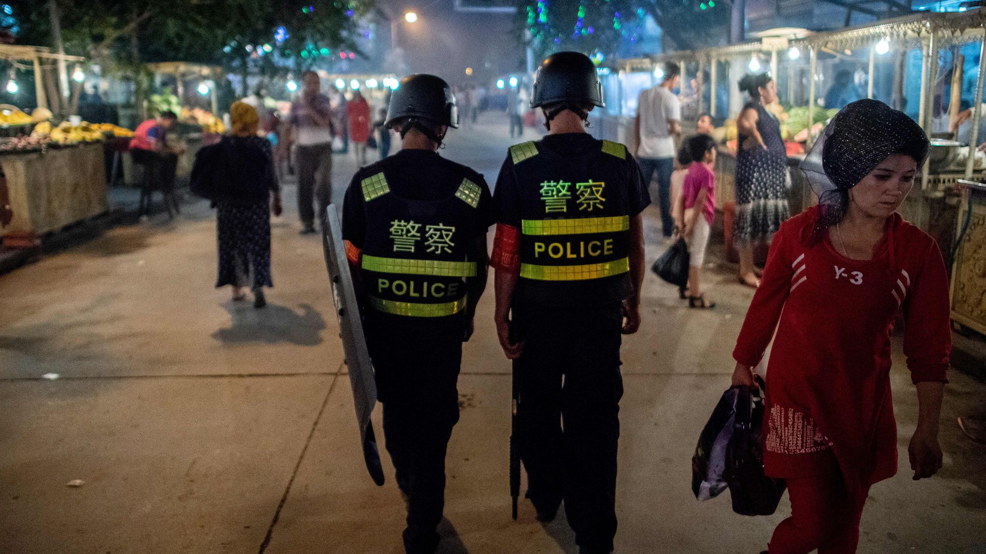 Photo of two police officers walking in a market