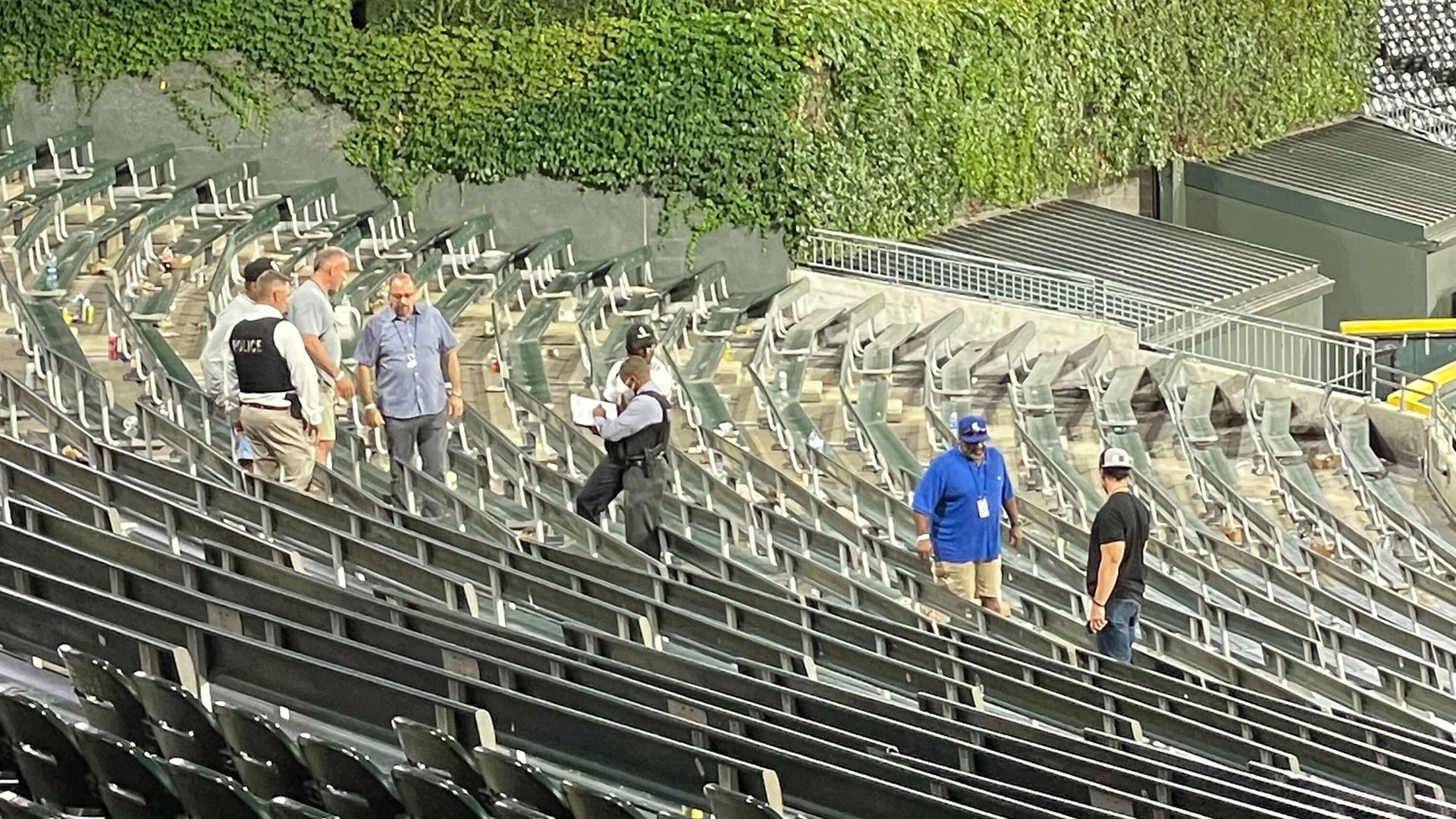 Photo of people looking at stadium bleachers after a baseball game