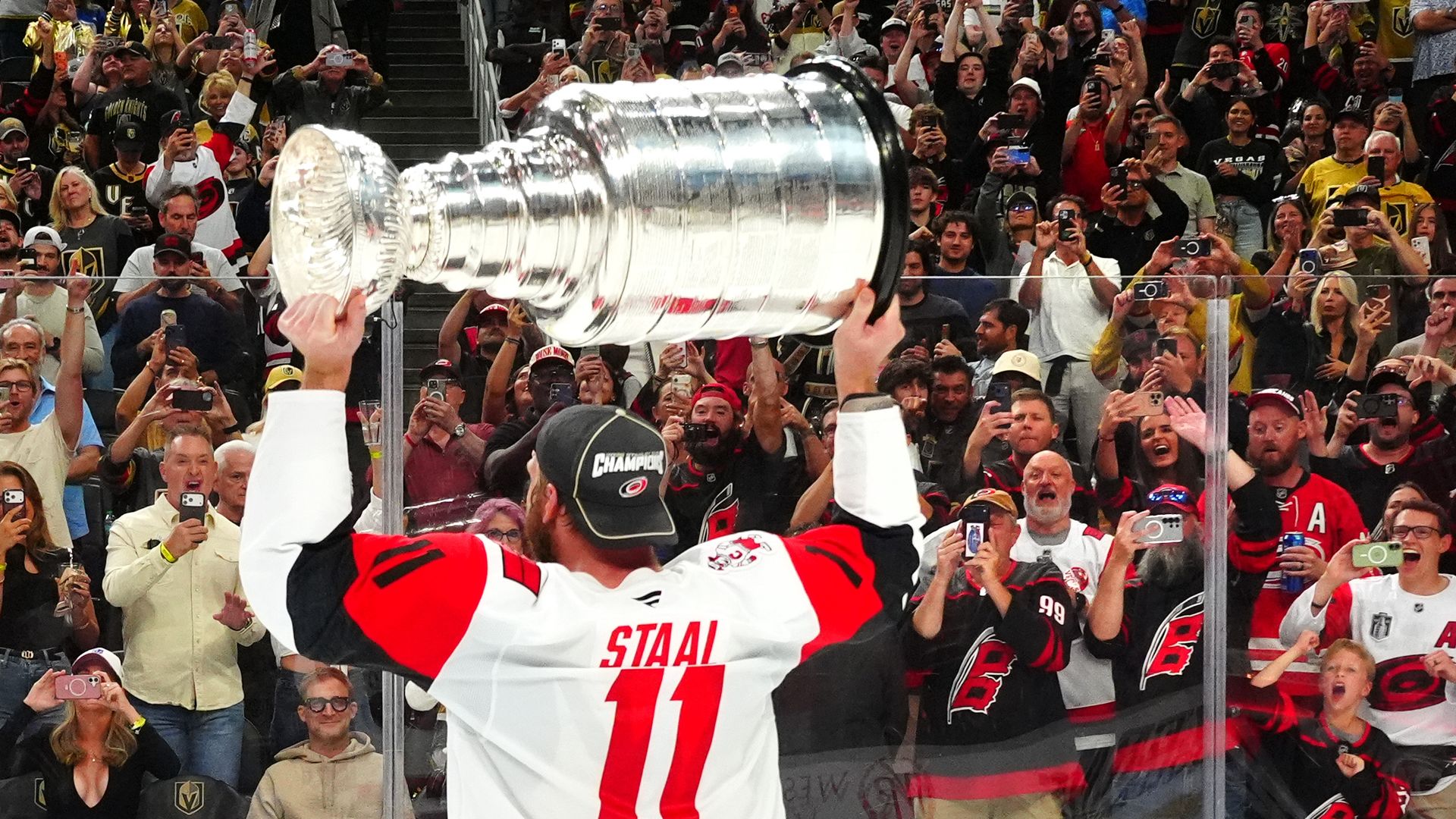 LAS VEGAS, NEVADA - JUNE 14: Jordan Staal #11 of the Carolina Hurricanes hoists the Stanley Cup to the fans after defeating the Vegas Golden Knights in Game Six of the 2026 NHL Stanley Cup Final between the Carolina Hurricanes and the Vegas Golden Knights at T-Mobile Arena on June 14, 2026 in Las Ve