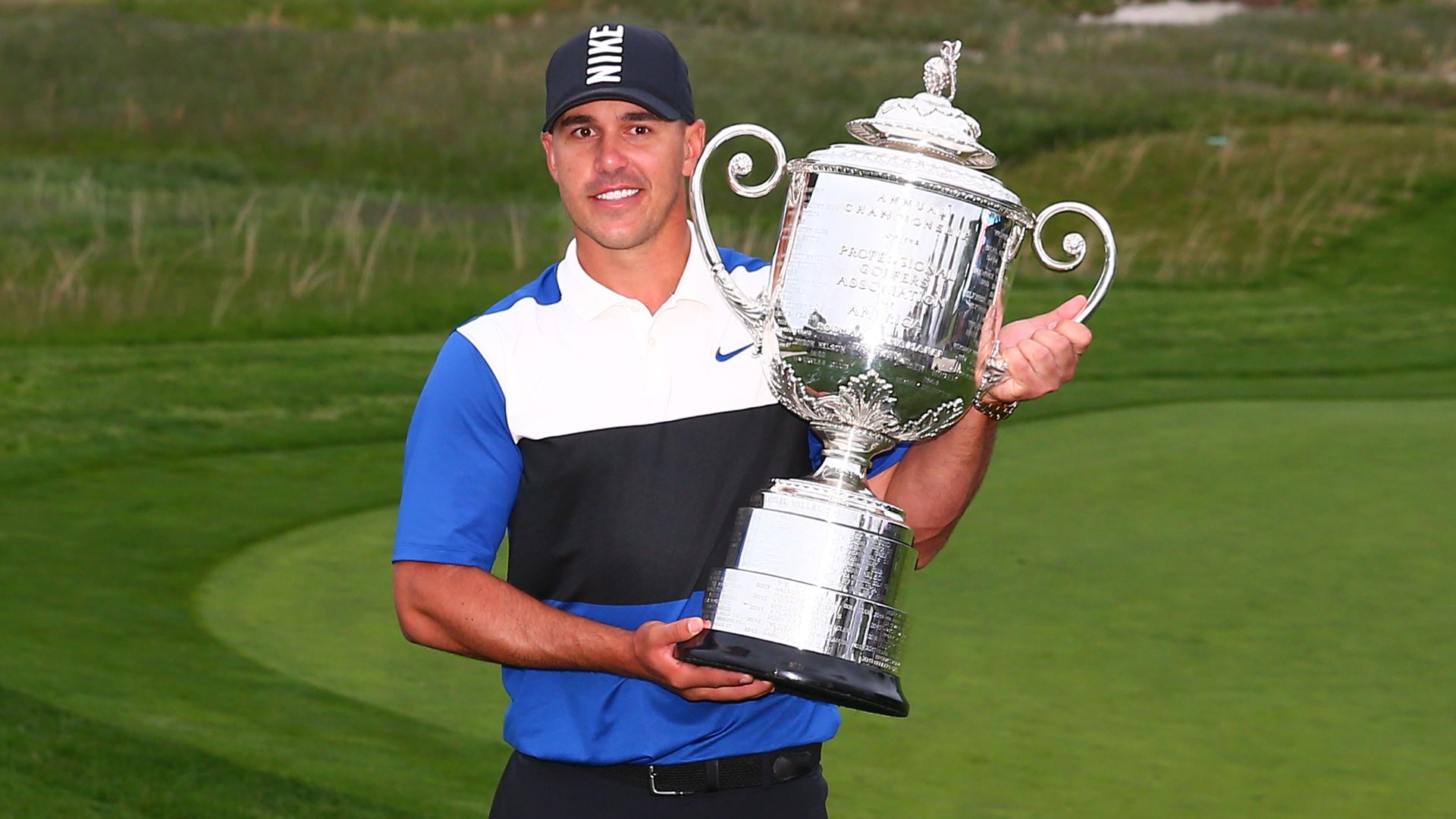 Brooks Koepka holding the PGA Championship trophy