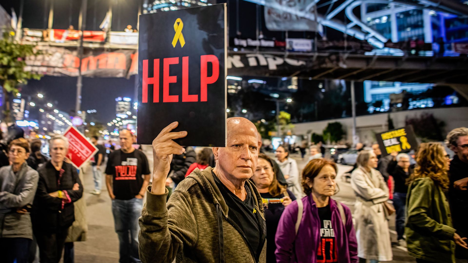 A man holds up a placard during a protest urging the government to secure a hostage release deal with Hamas.
