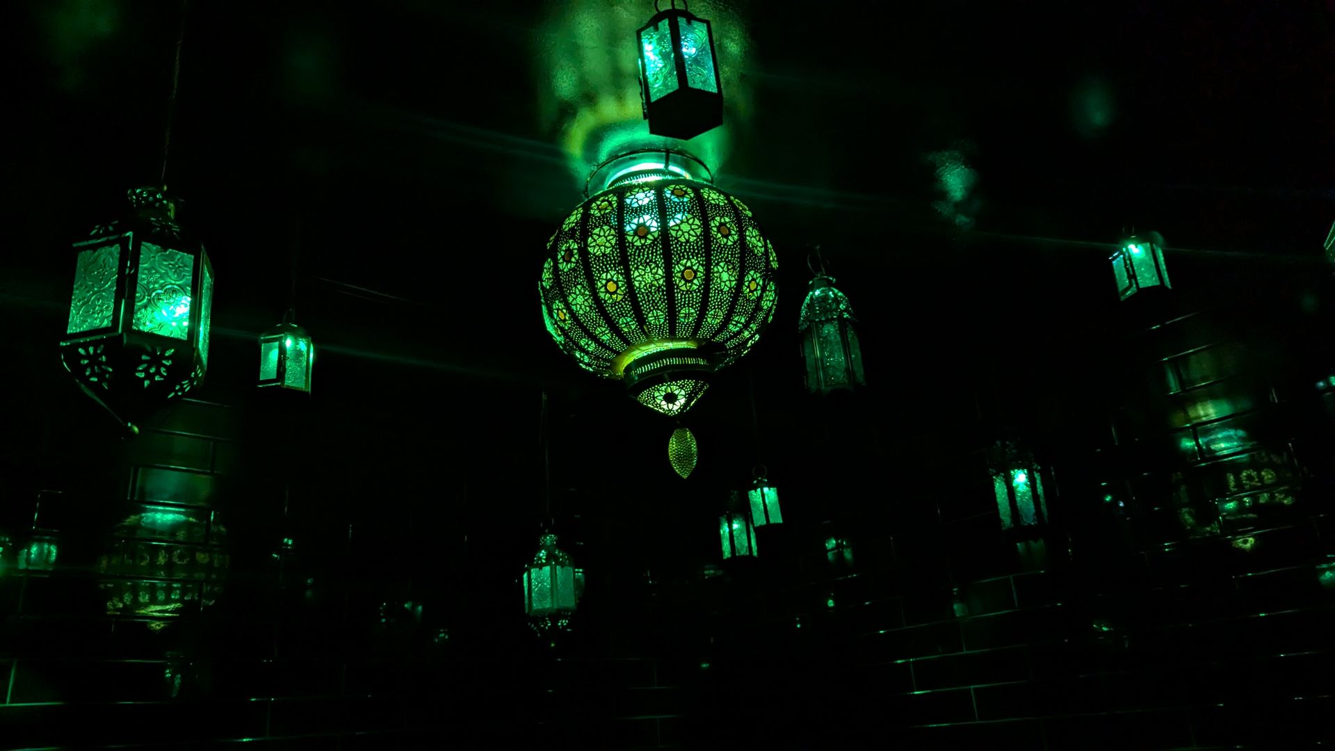 Green lanterns in a dark room.
