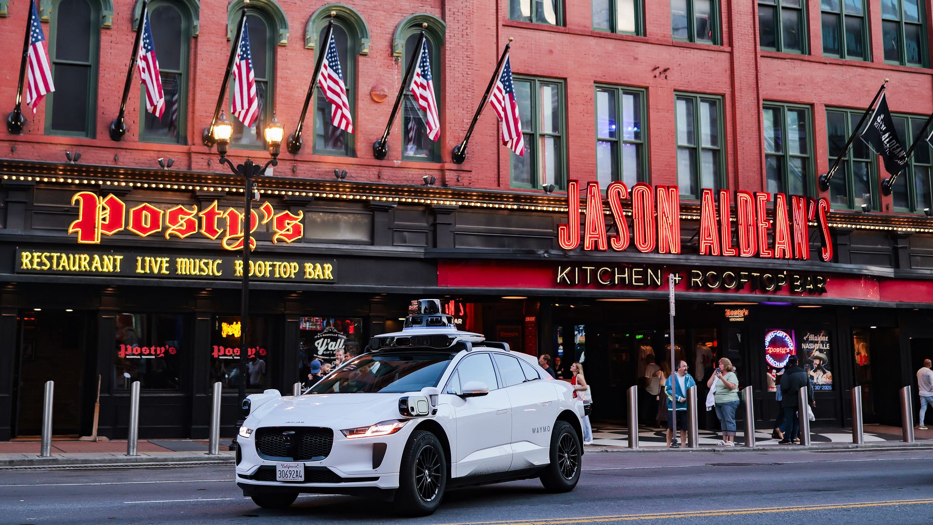 A Waymo drives visitors along Lower Broadway, known as Nashville's "Honky Tonk Highway," on June 01, 2026 in Nashville, Tennessee.