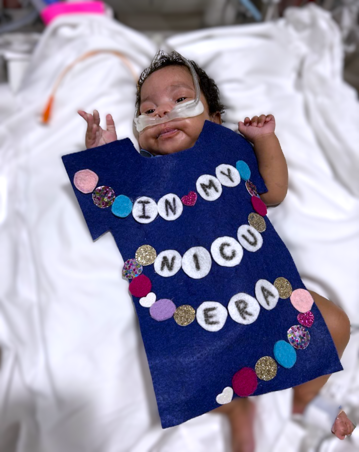 Image shows a baby in an outfit that says "In my NICU era."