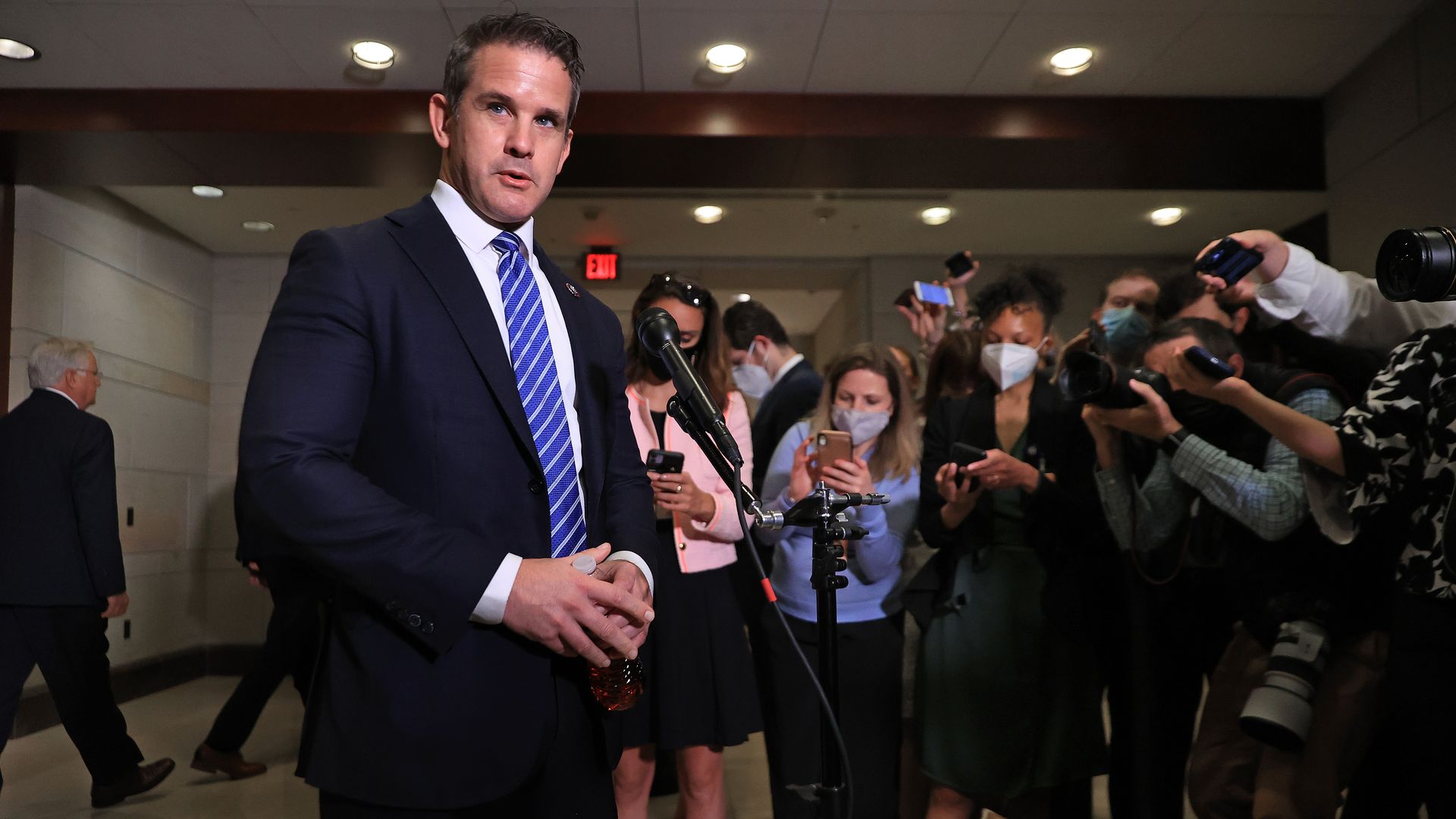 Rep. Adam Kinzinger is seen speaking to reporters after Liz Cheney's ouster as House conference chair.