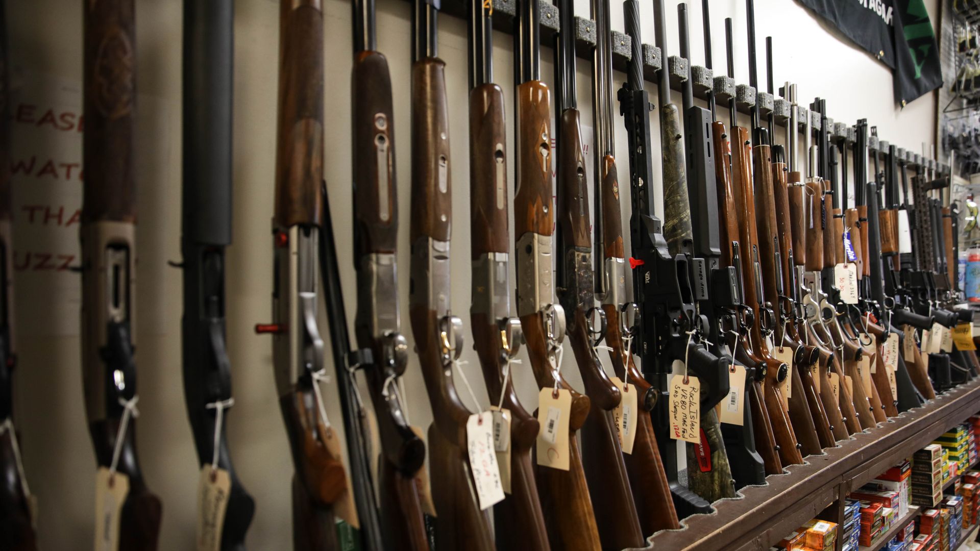 Photo of a row of rifles on sale at a gun store