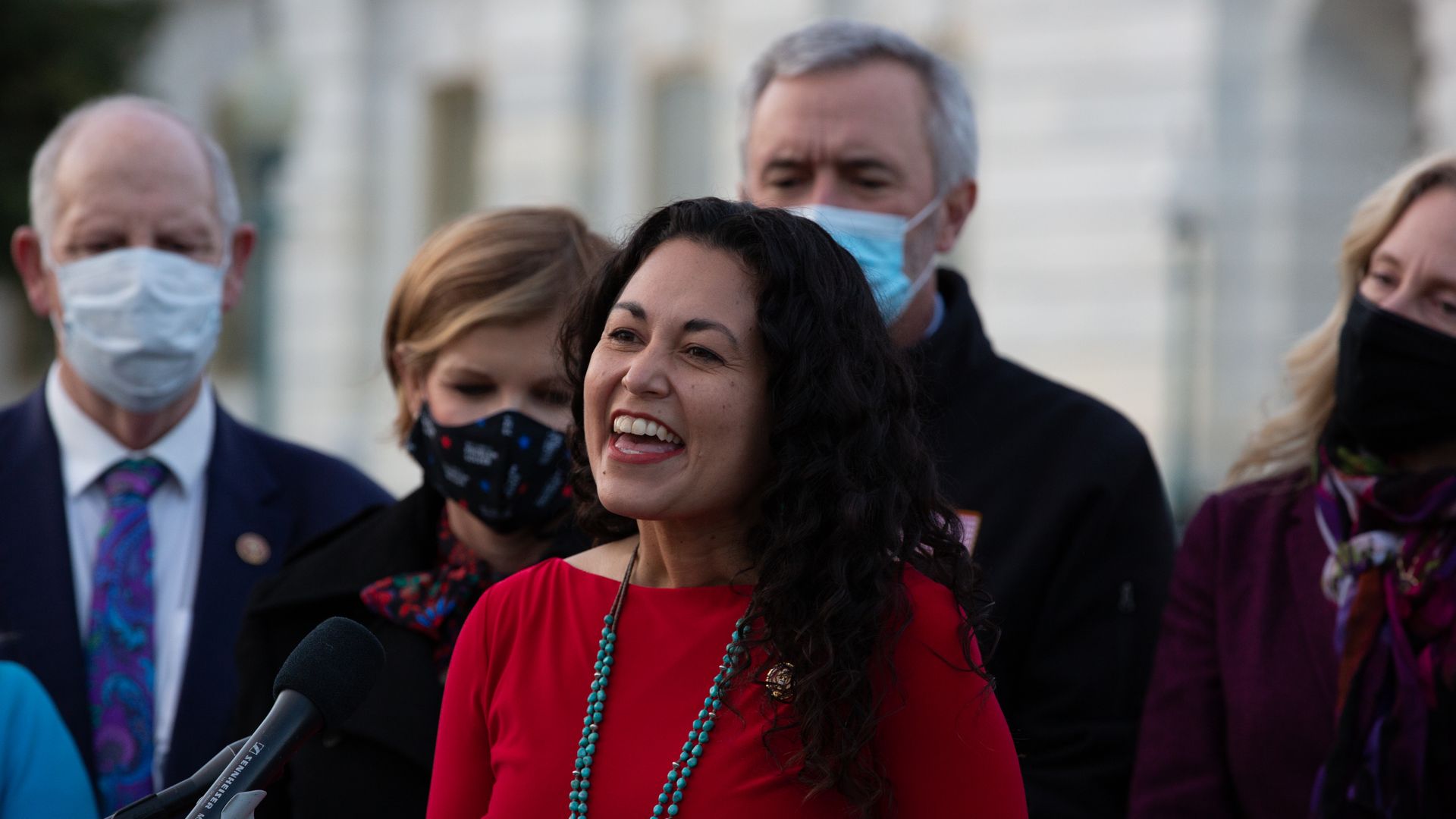 Then U.S.-Rep. Xochitl Torres Small (D-NM) speaks at a podium outside the US Capitol with members of the Problem Solvers Caucus.