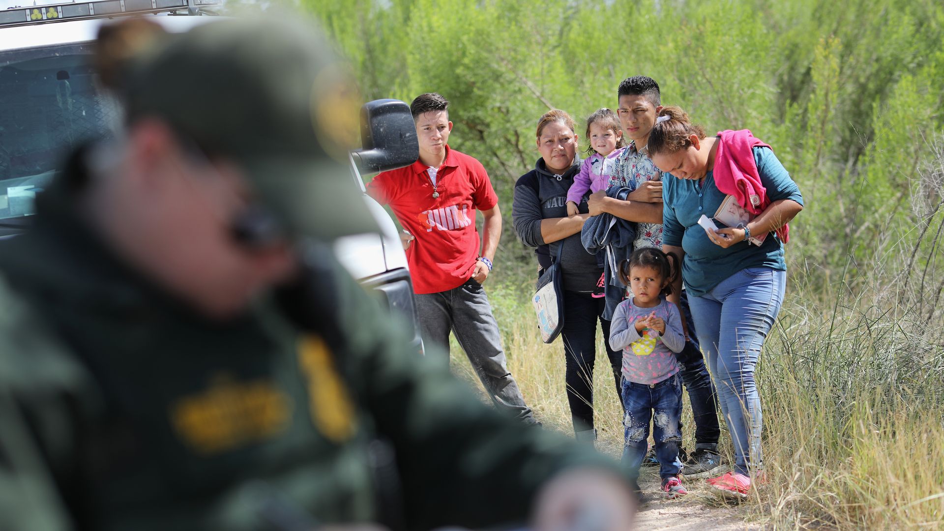 Central American asylum seekers wait as U.S. Border Patrol agents take groups of them into custody near McAllen, Texas last week. Photo: John Moore/Getty Images