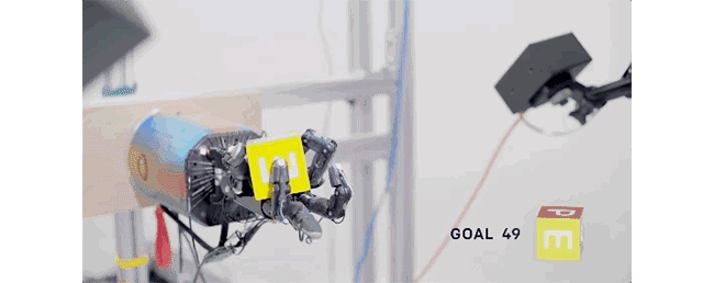 Giphy of robotic hand turning cube around in it